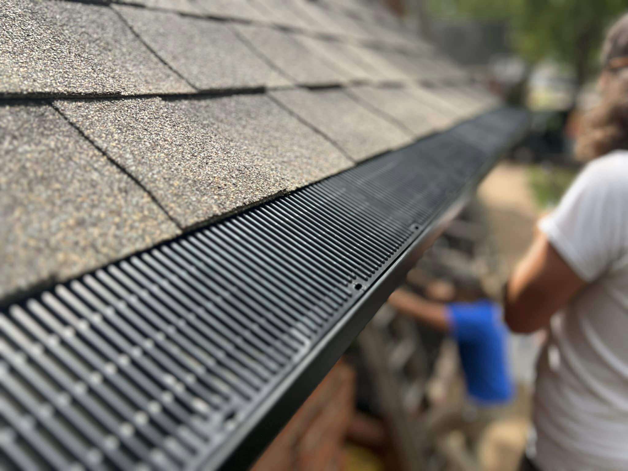 a gutter guard on a shingle roof