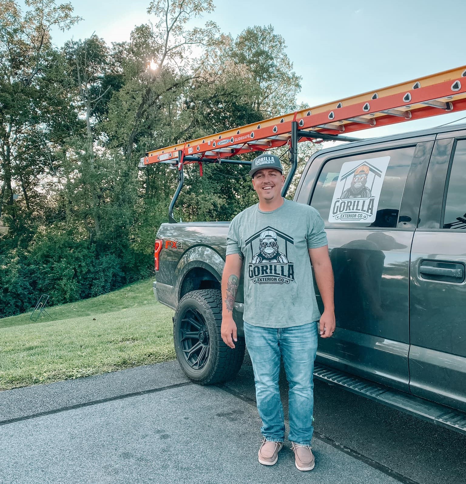 an expert roofer beside a truck