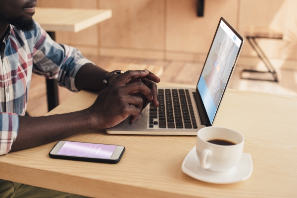 man using smartphone with Instagram and laptop