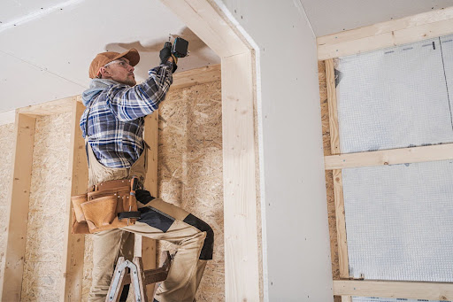 A man fixing the ceiling of a house