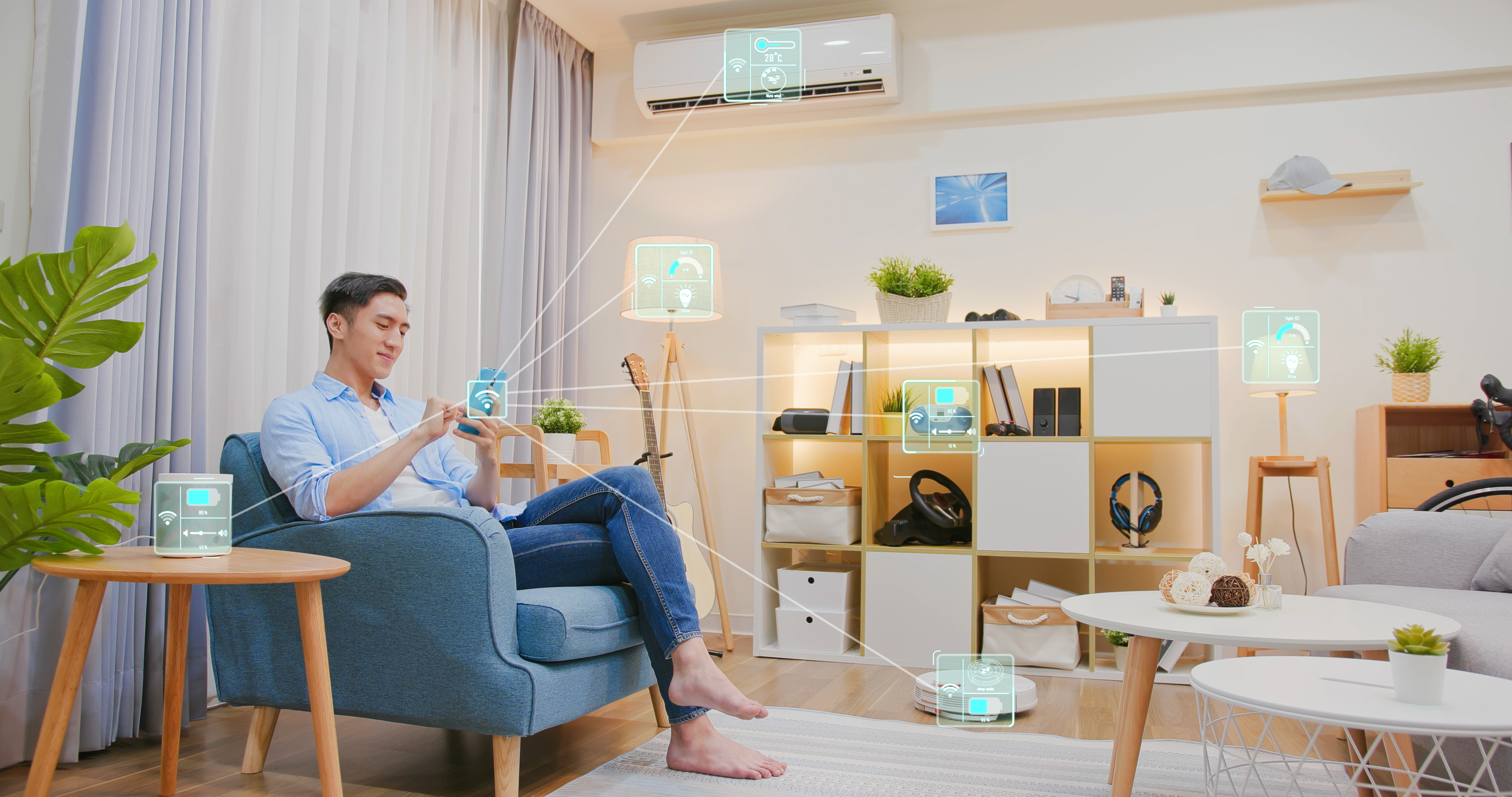 A man engrossed with a smart device in a cozy living room.