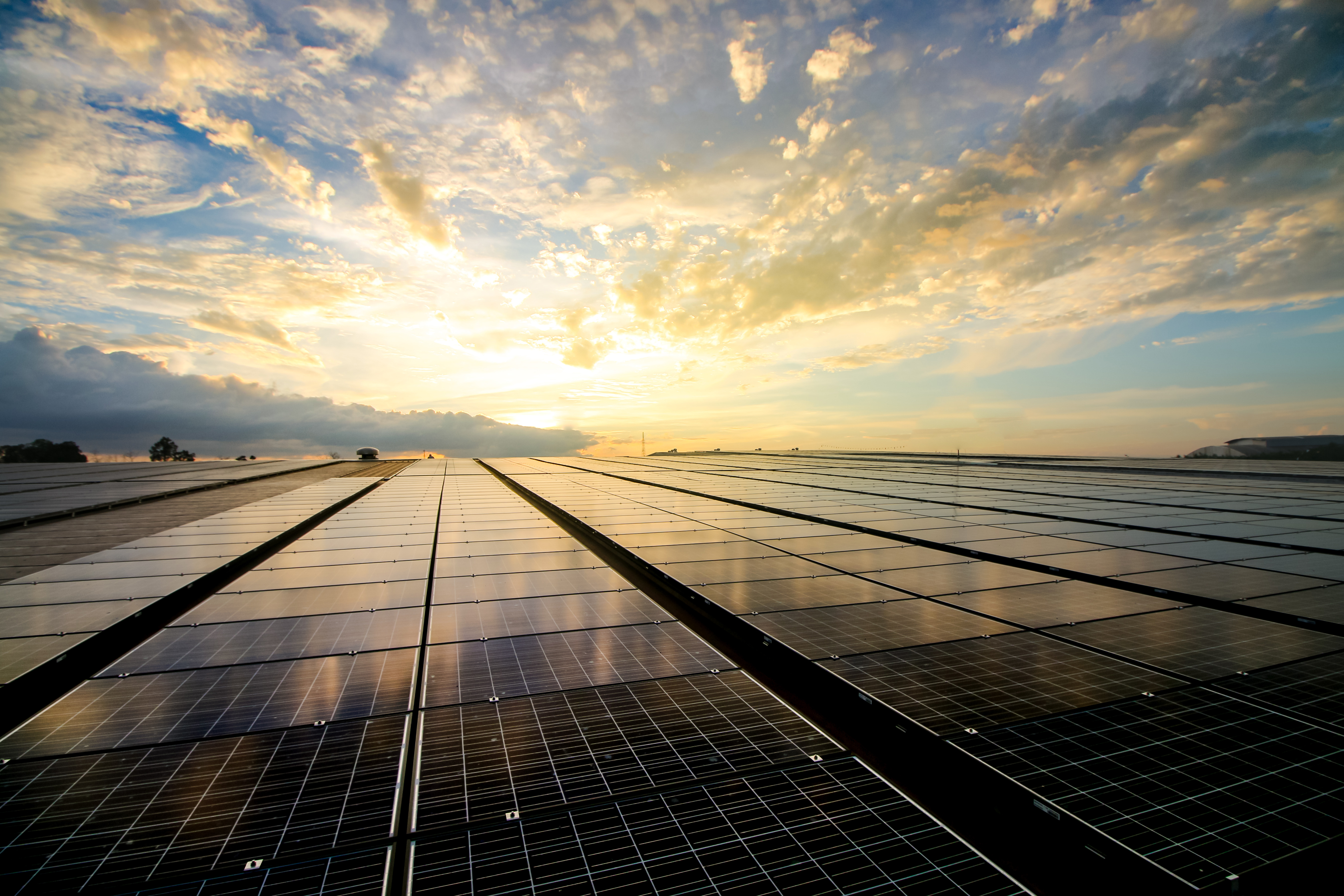 Solar panels on a roof at sunset, harnessing clean energy from the sun.