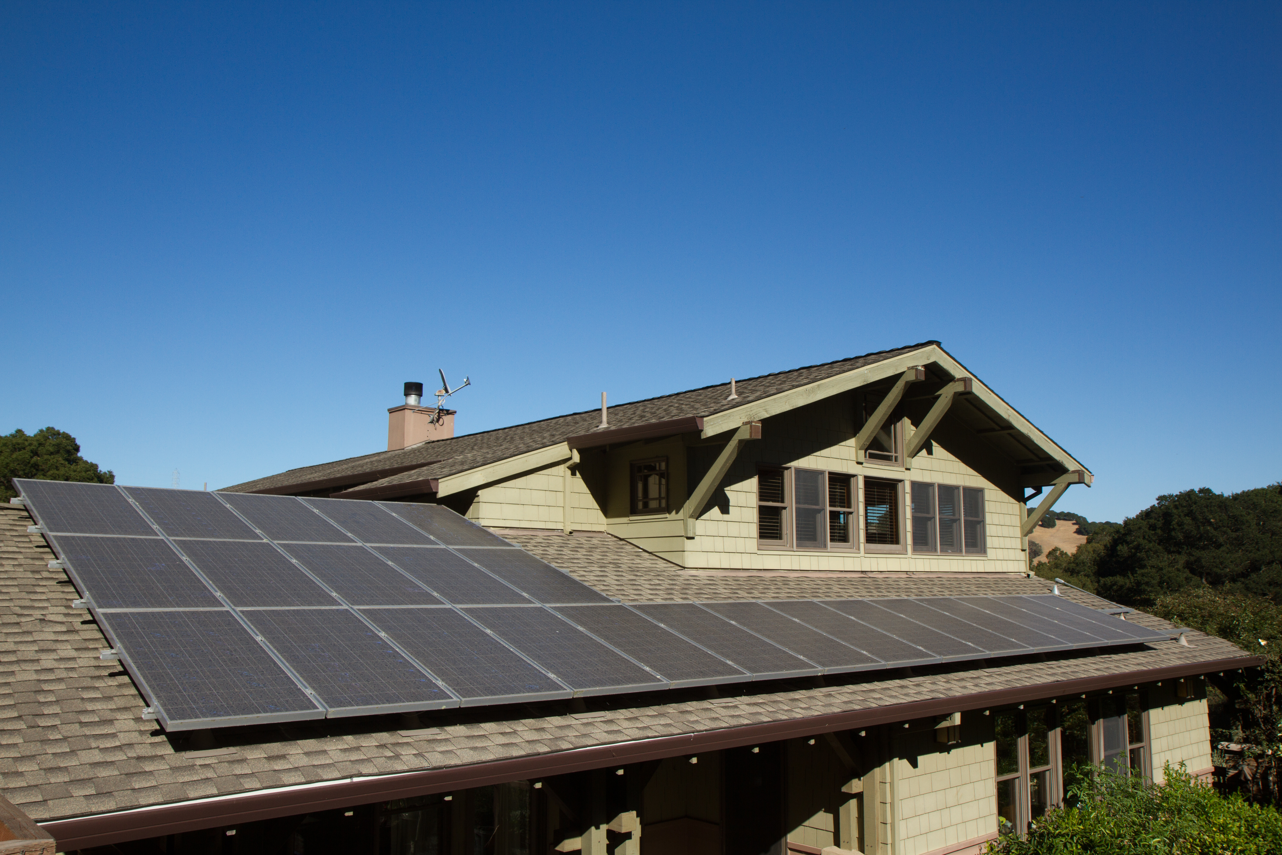 A full view of a house with a solar panel all over the roof.