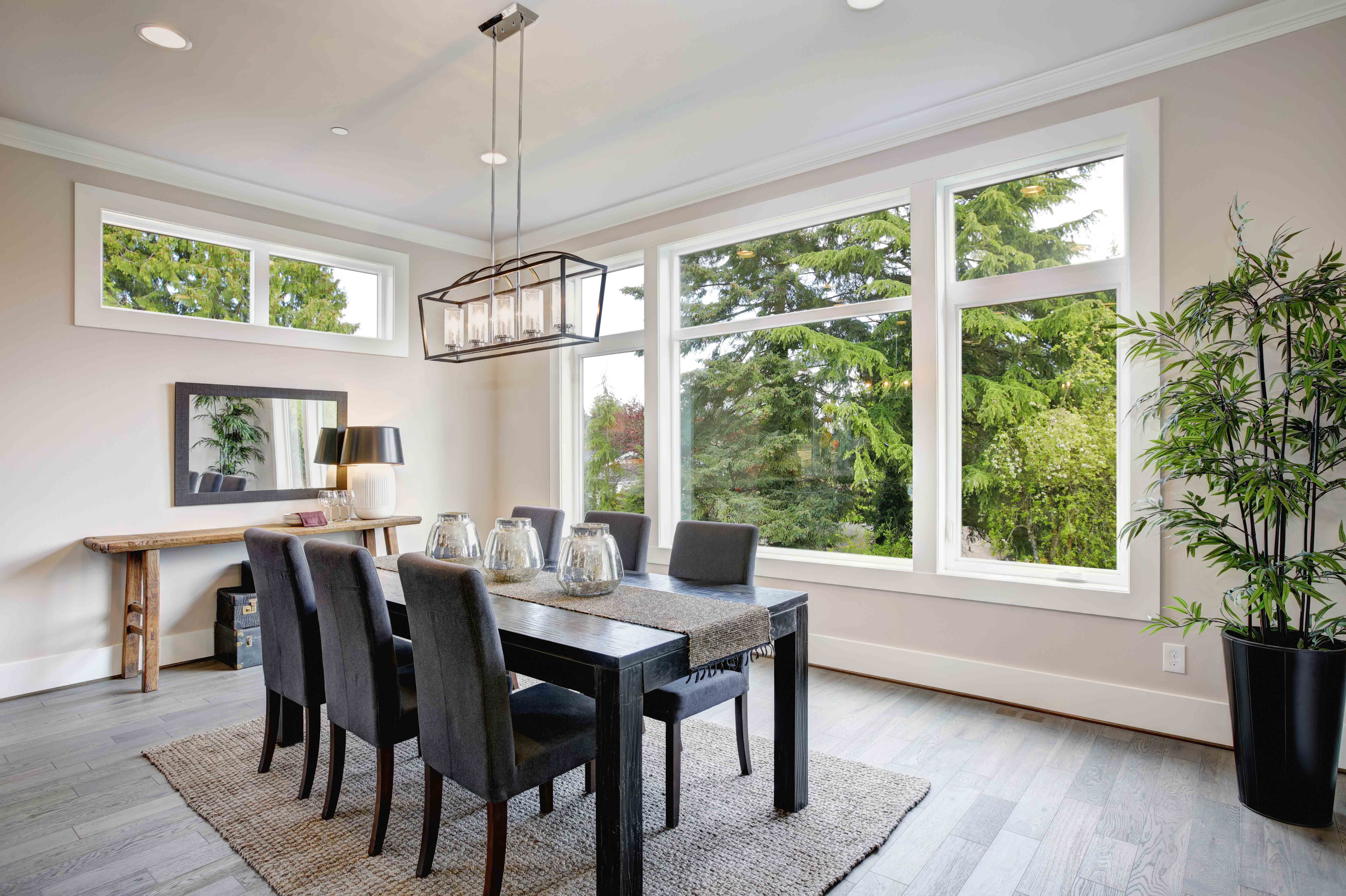 Cozy dining room setup with table and chairs.