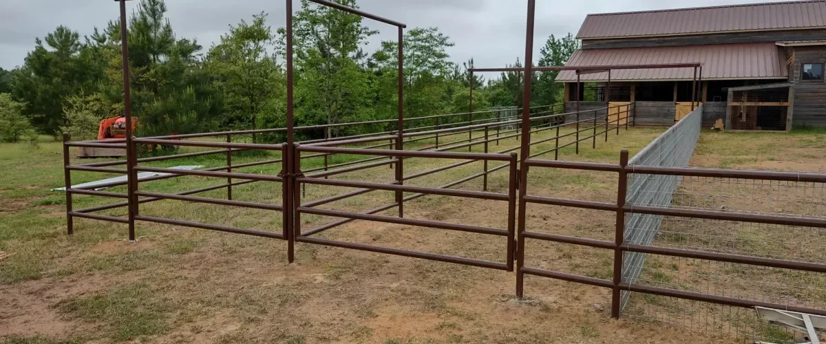 Horse panel fencing installation at ranch property with durable metal frame Horse panel fencing installation at ranch property with durable metal frame