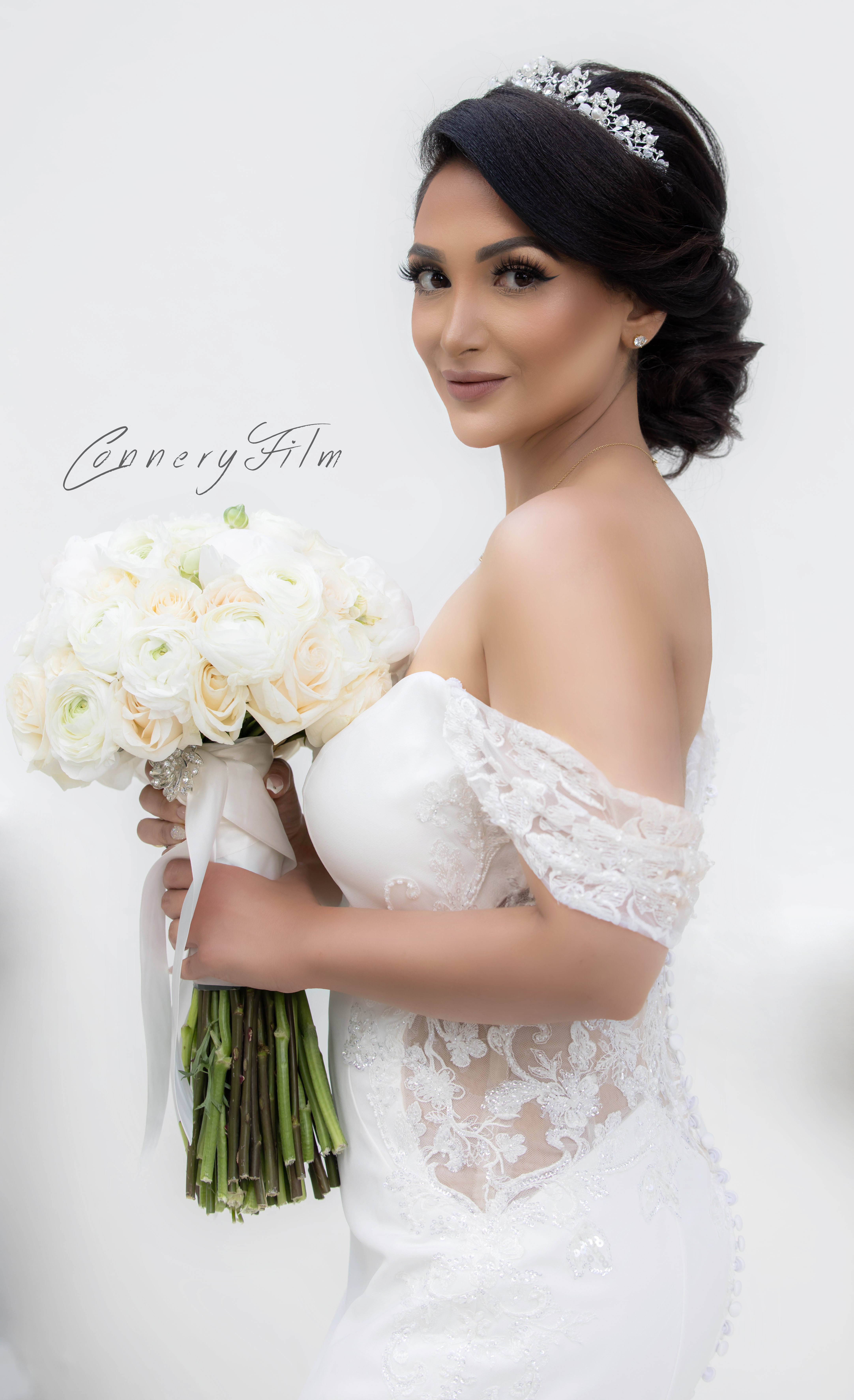 Elegant bride sharing a joyful laugh while getting ready, capturing the relaxed and fun atmosphere of her luxury wedding morning.