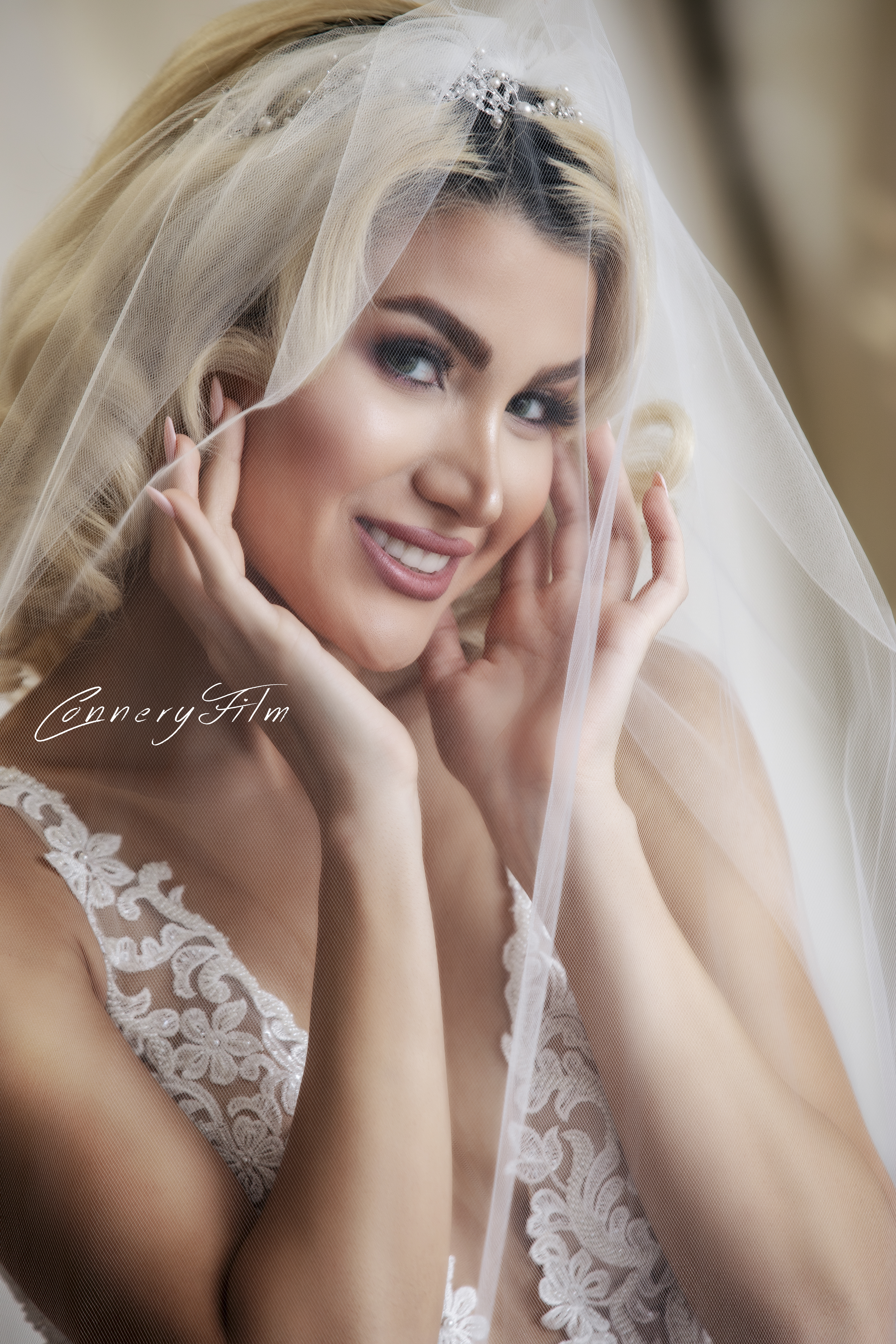 "Elegant bride with dark hair smiling, wearing a lace off-shoulder wedding gown, showcasing her radiant and joyful pre-wedding glow." "Elegant bride with dark hair smiling, wearing a lace off-shoulder wedding gown, showcasing her radiant and joyful pre-wedding glow."