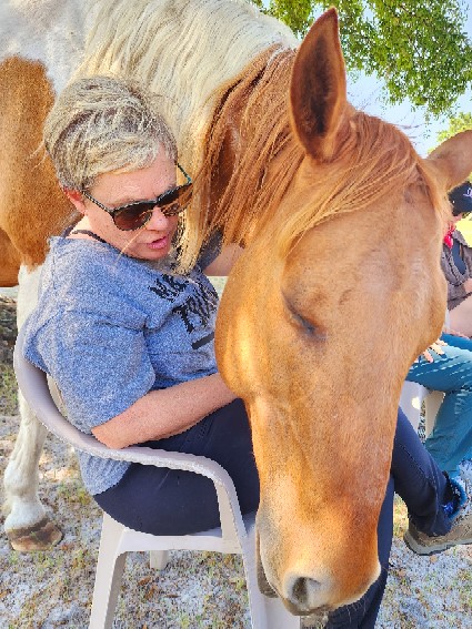 woman sitting with horse