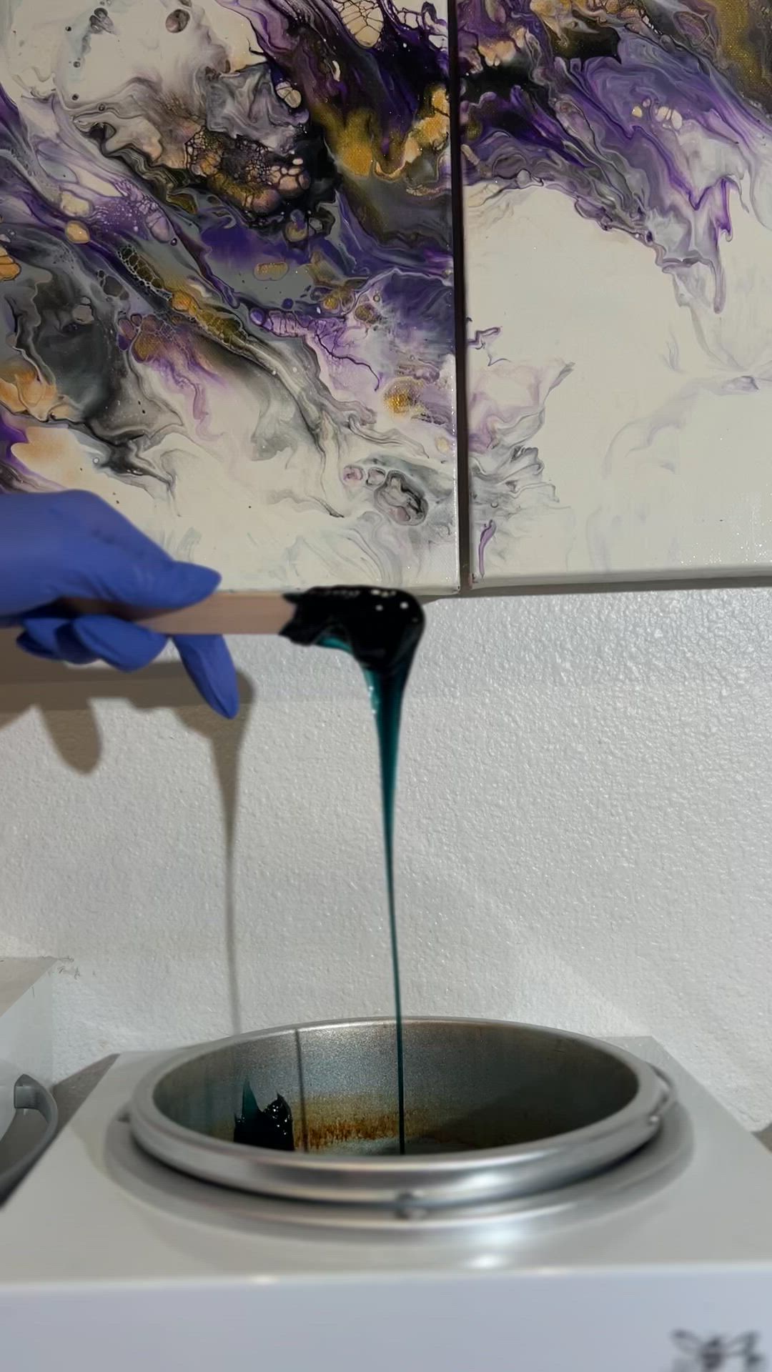 wax stick with dark hot wax dripping from the stick