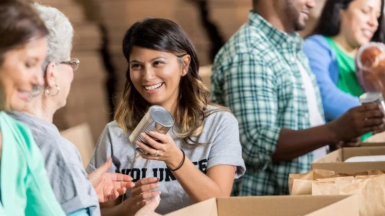 A girl happily volunteering in donation drive