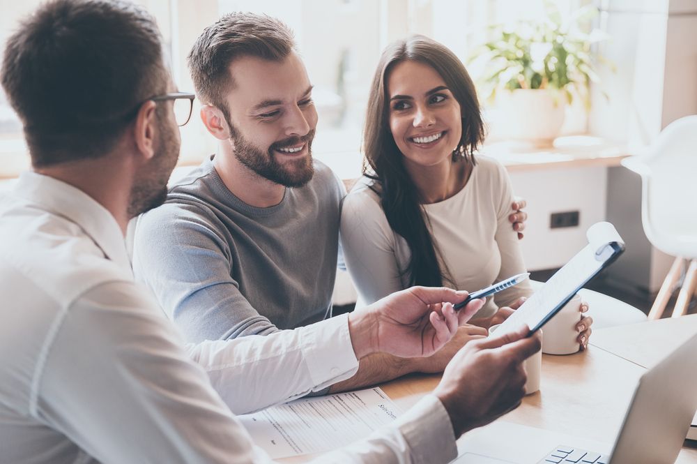 A couple talking to an agent