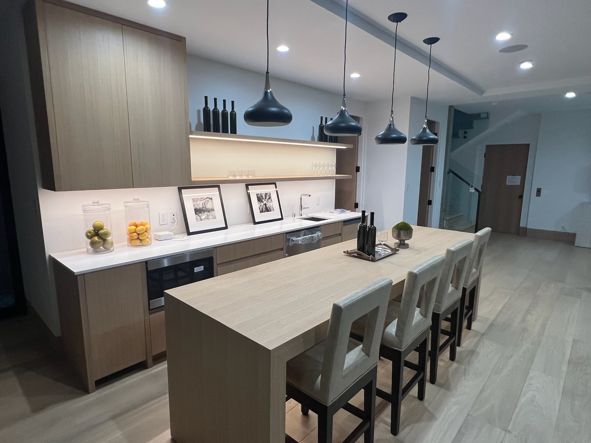 Modern kitchen remodel in Newbury Park, CA with open layout, custom wood cabinetry, and large center island.