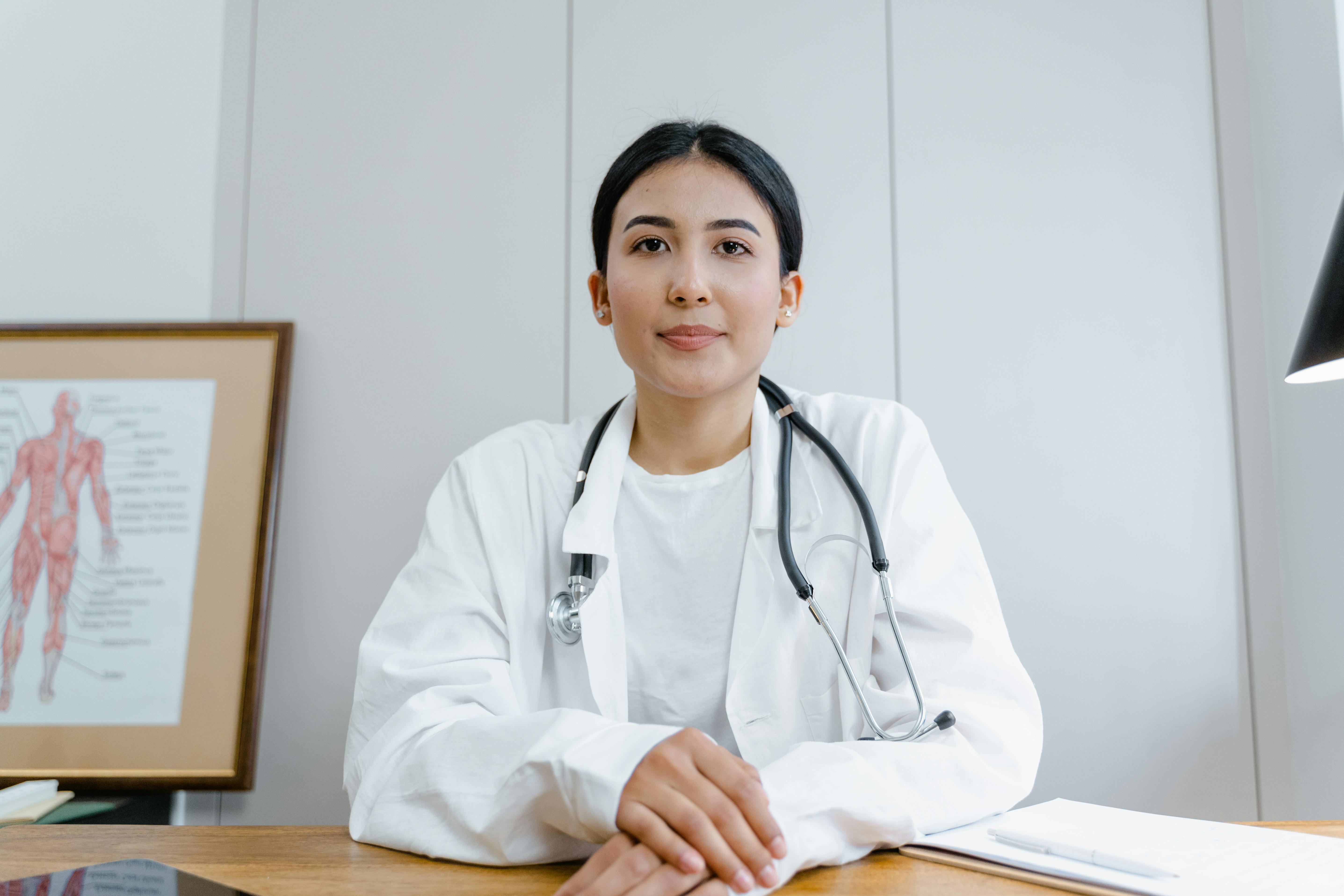 A confident female doctor in a white coat with a stethoscope sitting at her desk, representing Royal Wound Care’s commitment to expert wound management and patient care. A confident female doctor in a white coat with a stethoscope sitting at her desk, representing Royal Wound Care’s commitment to expert wound management and patient care.