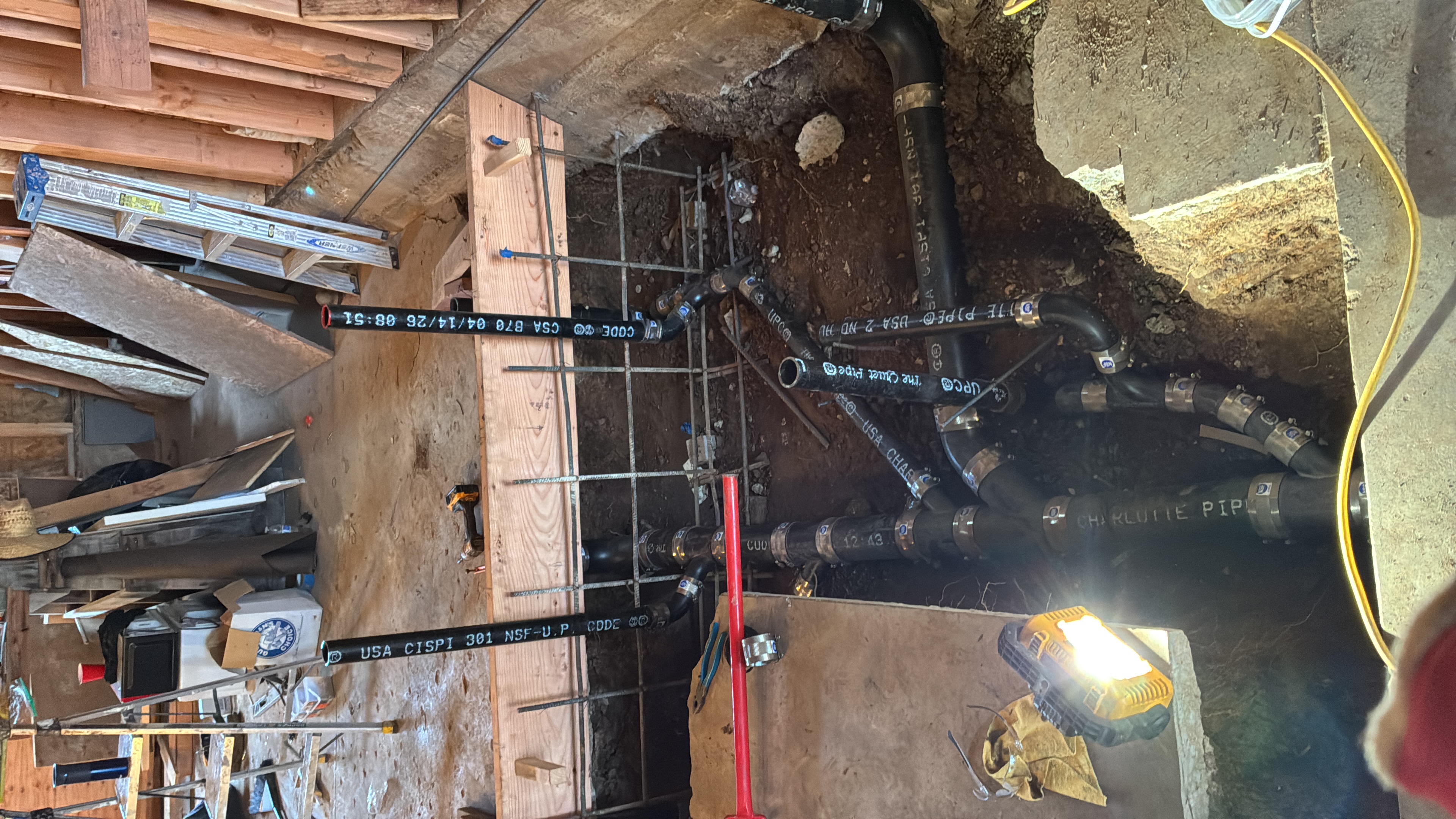 Drain piping beneath an opened floor section
