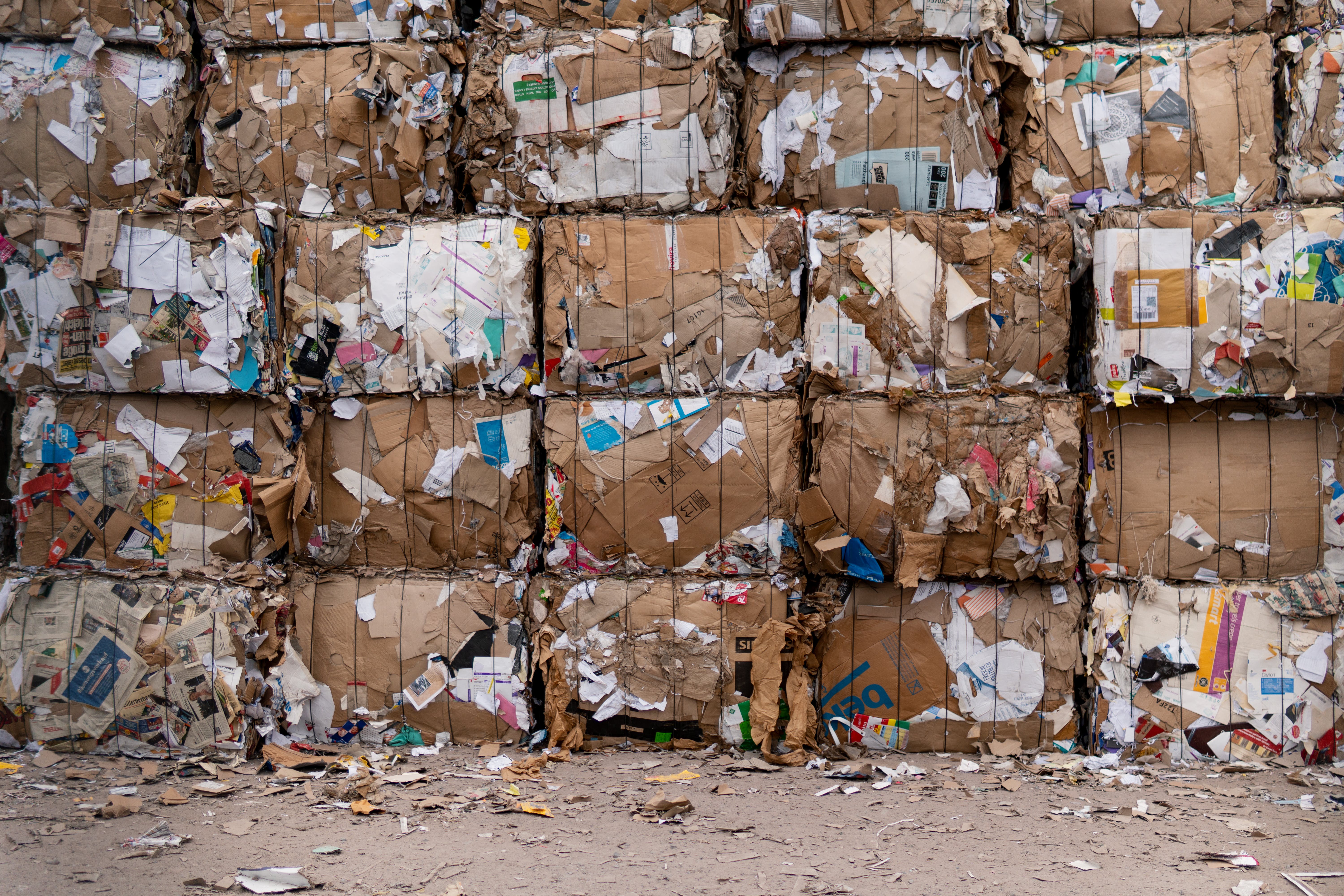 Large stacks of compressed cardboard boxes ready for recycling, emphasizing the importance of sustainability and reducing waste in North Kansas City.
