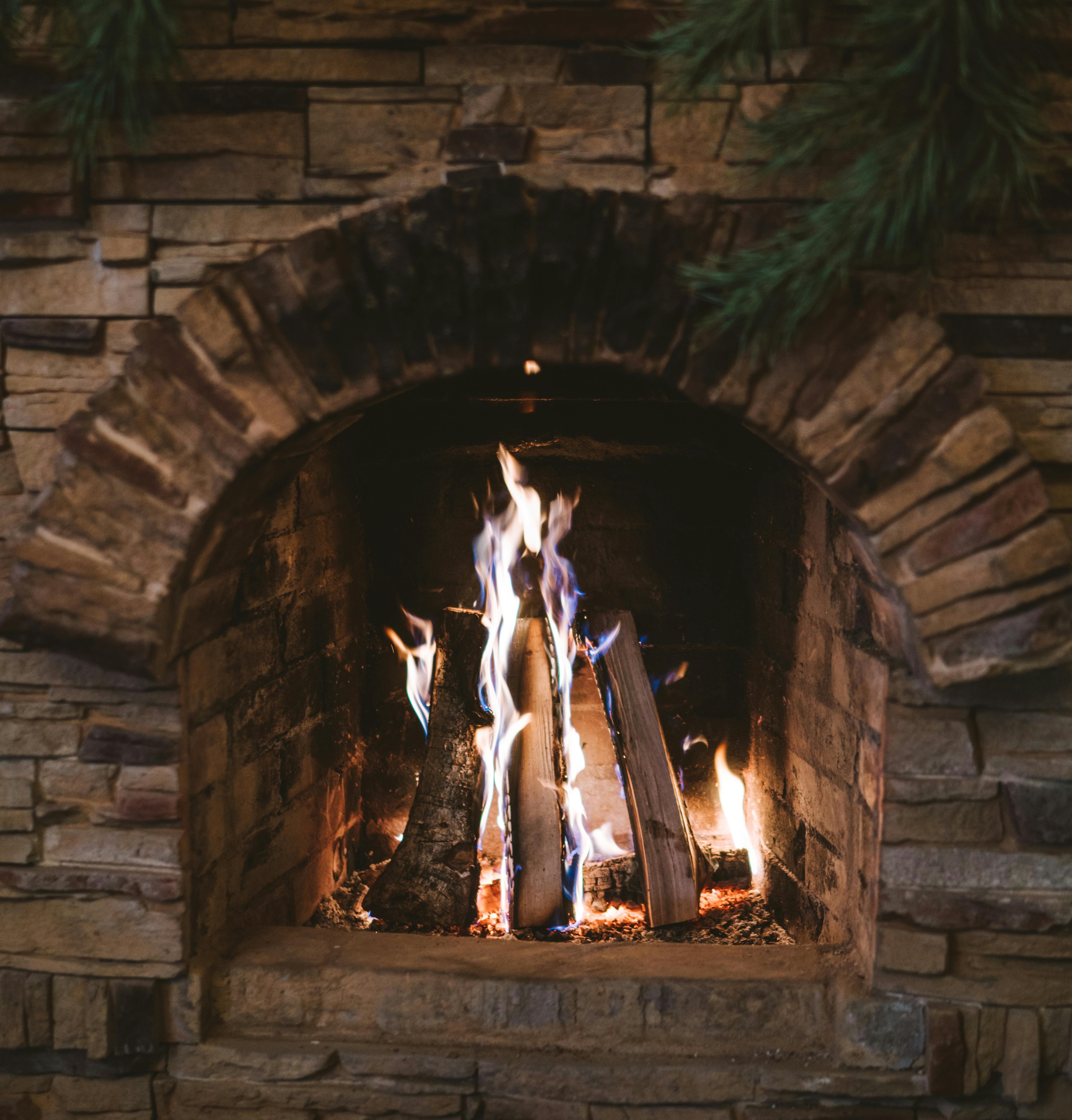 Warm fire burning in a fireplace, representing a gathering place for warmth and community during power outages.