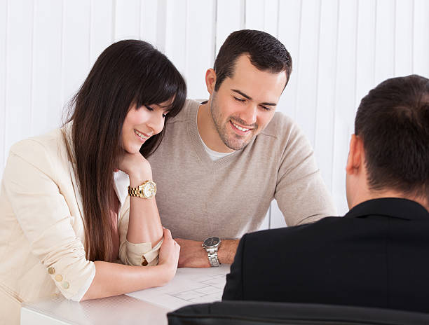 Insurance agent helping a customer with a smile.