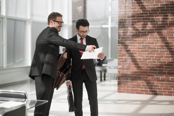 Successful insurance agents discussing paperwork.