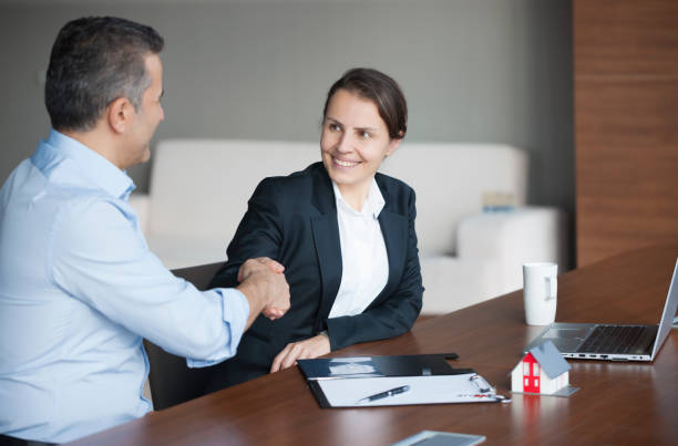 Life insurance agent selling policy to hotel manager.