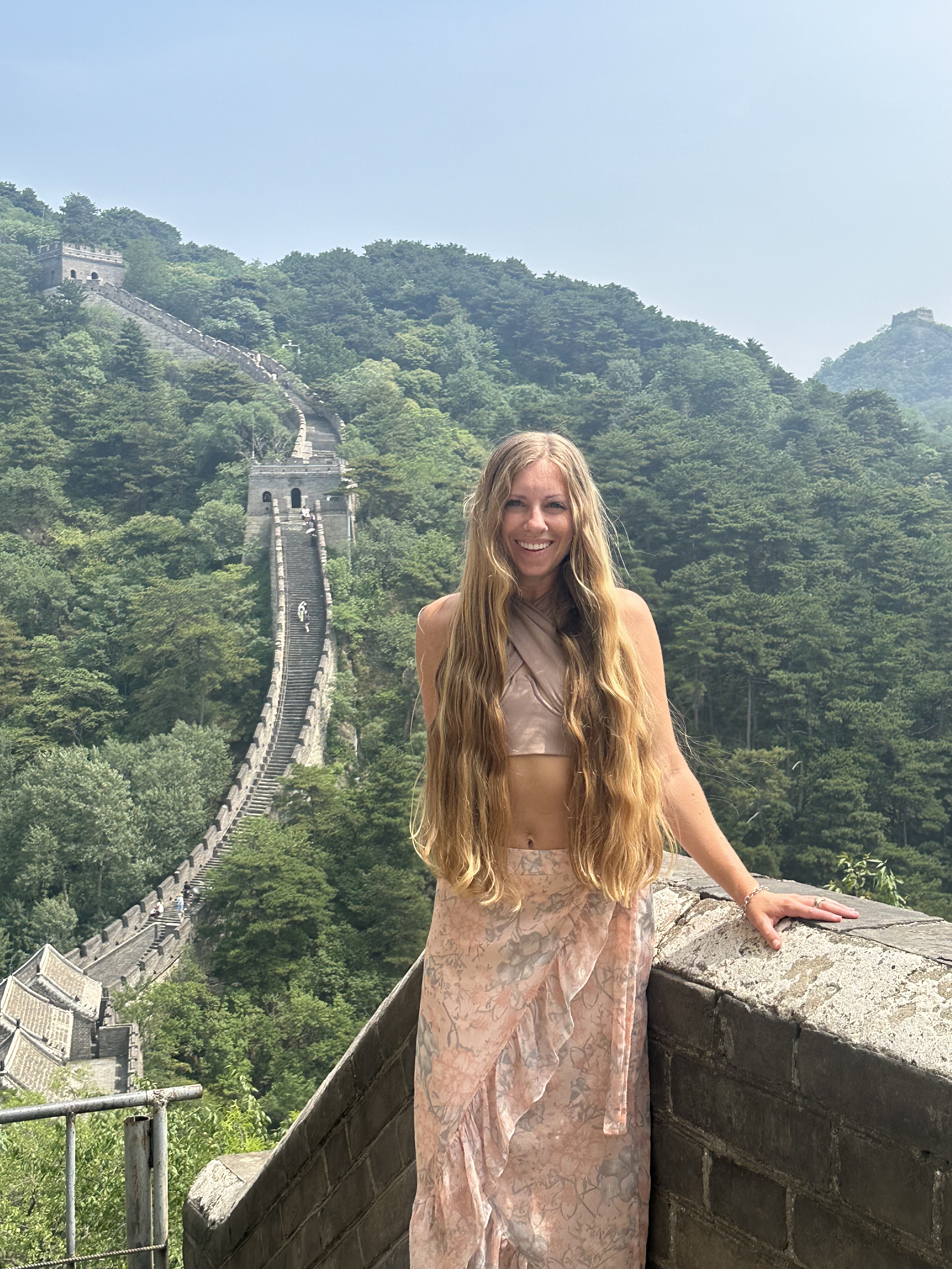 girl posing at the great wall of china on a layover trip