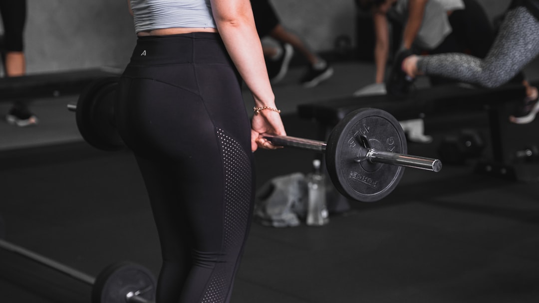 Busy mom strength training with dumbbells to build muscle and boost fat loss with Tirzepatide support.