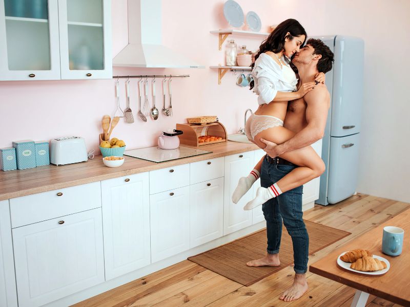 alt: image of a man and woman getting ready to have sex in the kitchen