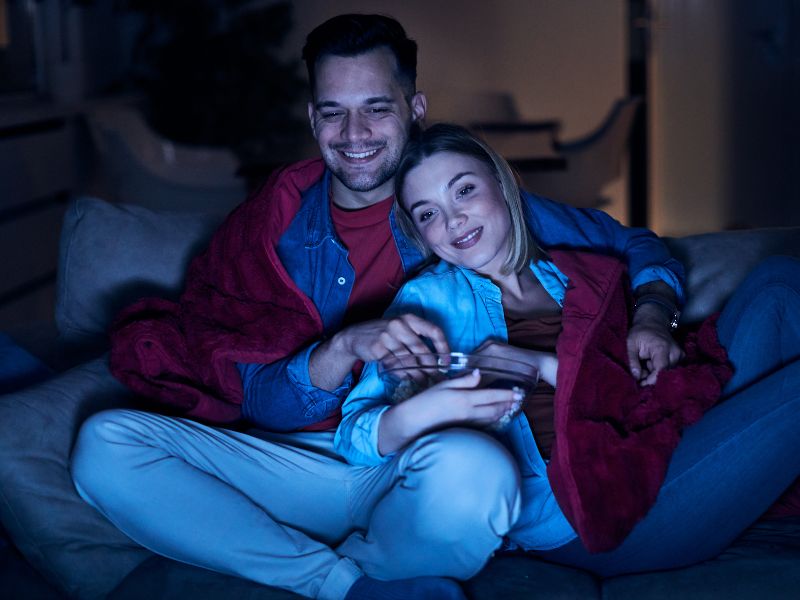 Image of a woman and man watching a movie at home Image of a woman and man watching a movie at home