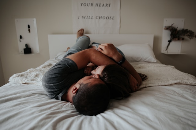 Couple holding each other on a bed