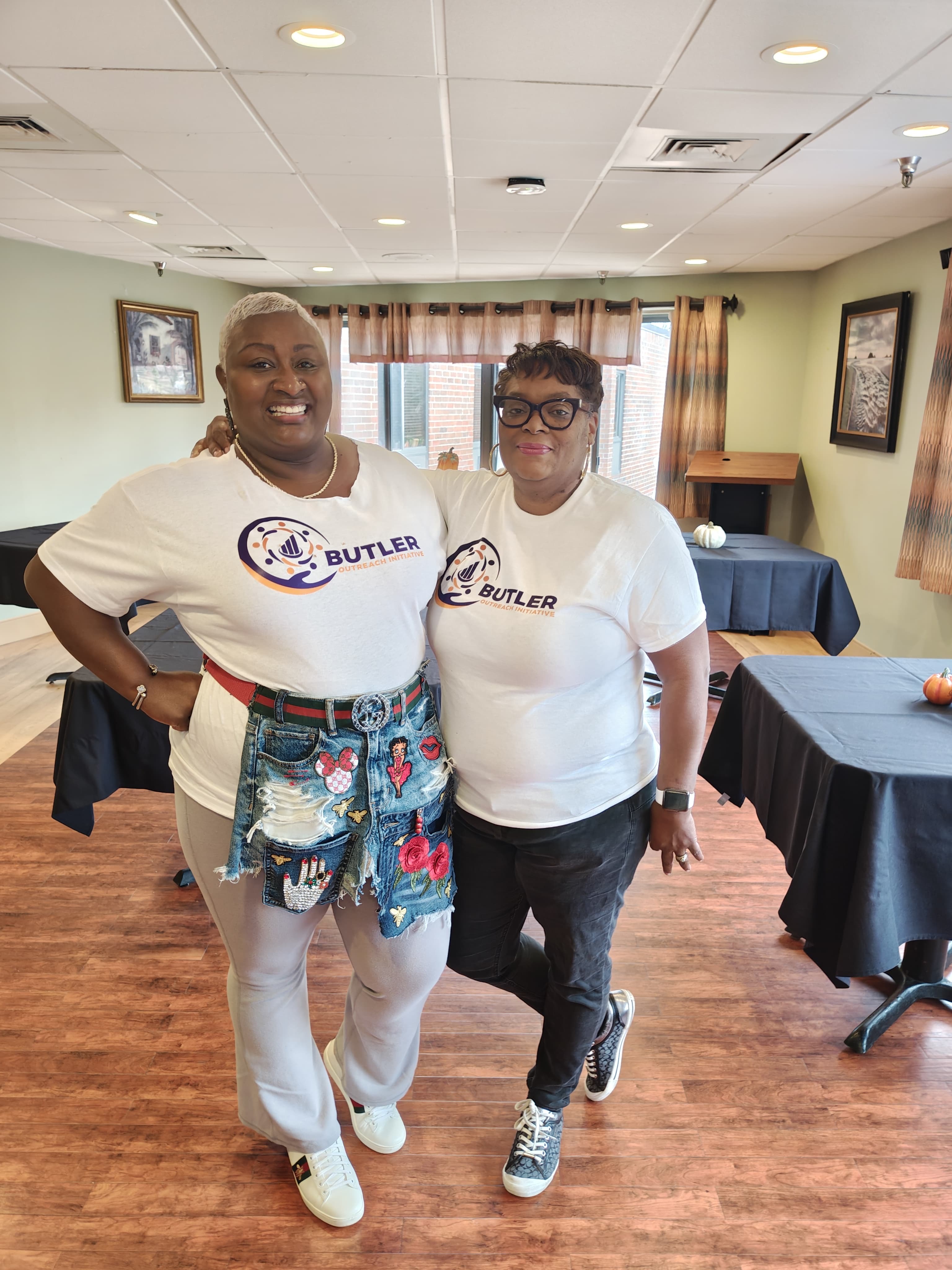 Community outreach moment showing volunteers and supplies during a Butler Outreach Initiative event