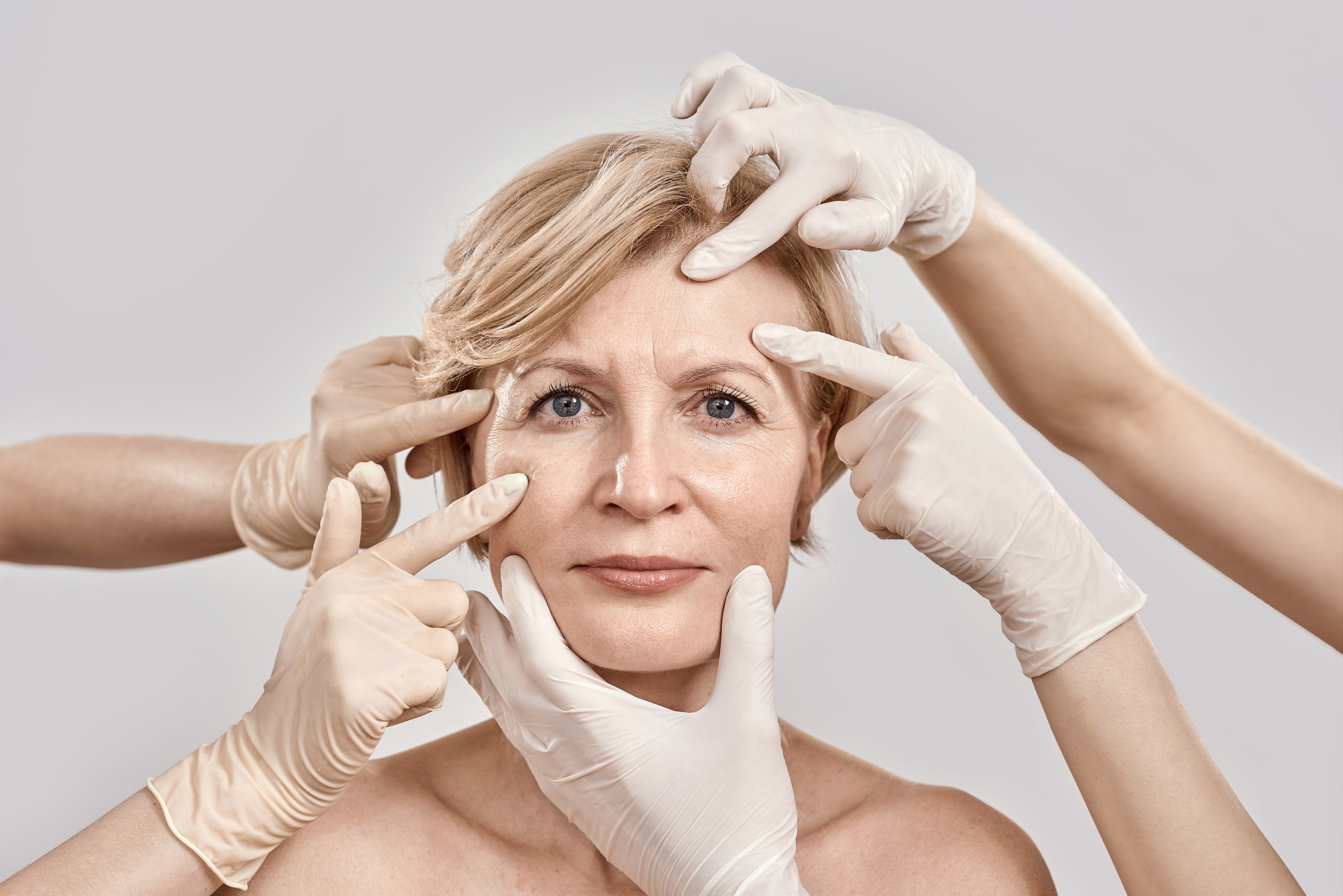 facial aesthetics treatment - mature woman's consultation with medical professional