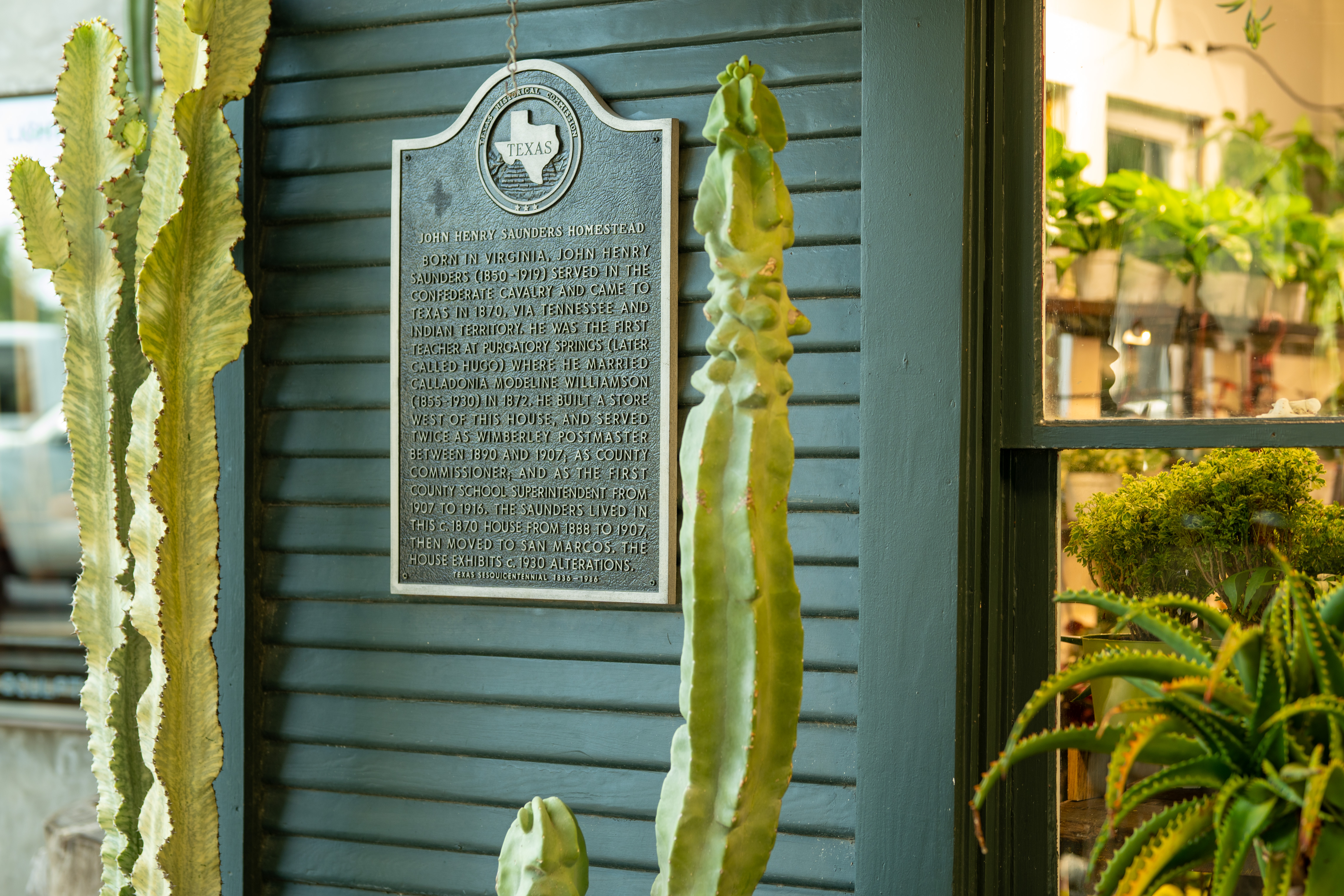 Historic Texas marker on the John Henry Saunders Homestead in Wimberley, TX, telling the story of early settlers and the town’s roots. Historic Texas marker on the John Henry Saunders Homestead in Wimberley, TX, telling the story of early settlers and the town’s roots.