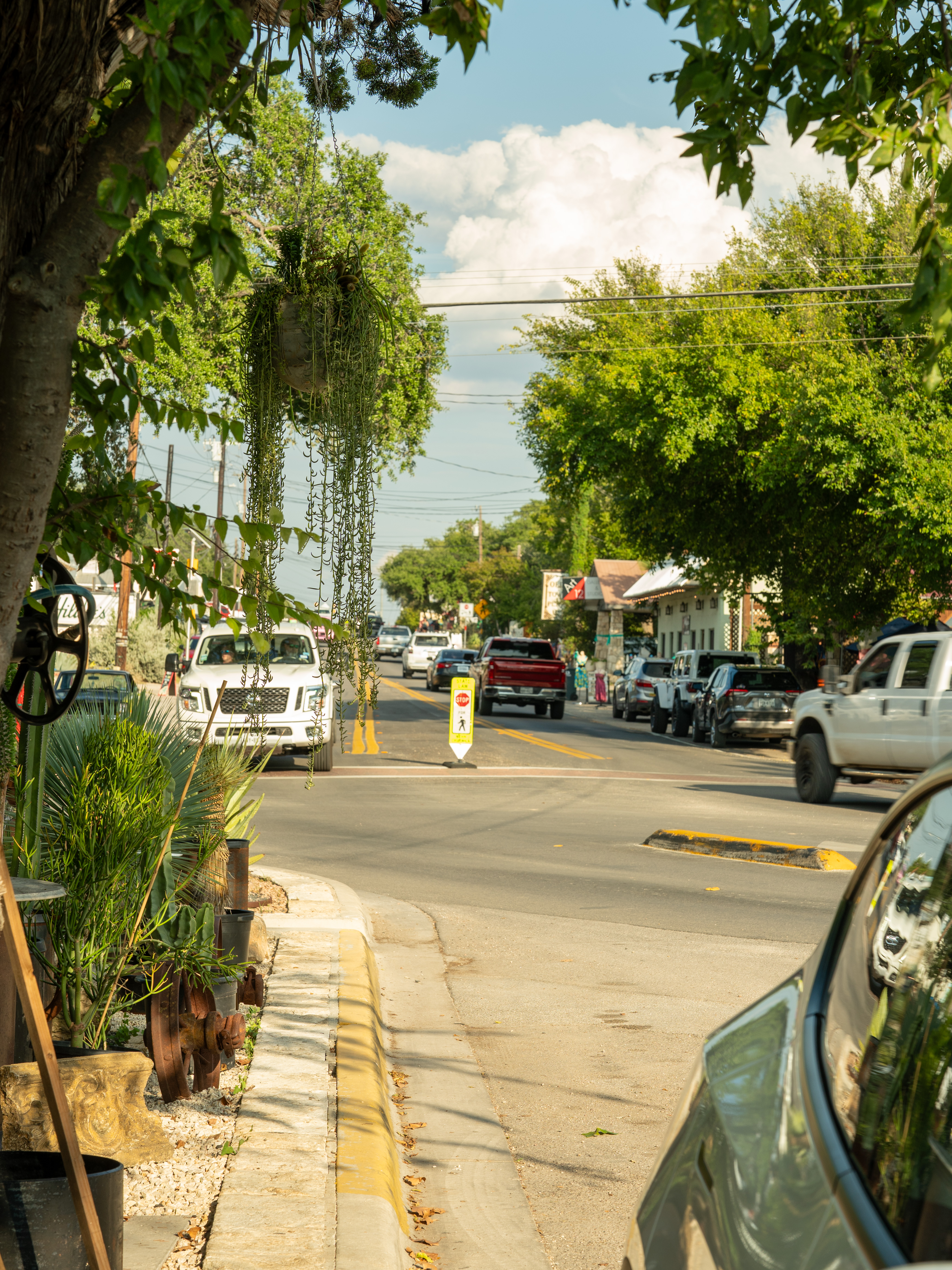 Street view of downtown Wimberley Square lined with shops, trees, and local charm in the Texas Hill Country. Street view of downtown Wimberley Square lined with shops, trees, and local charm in the Texas Hill Country.