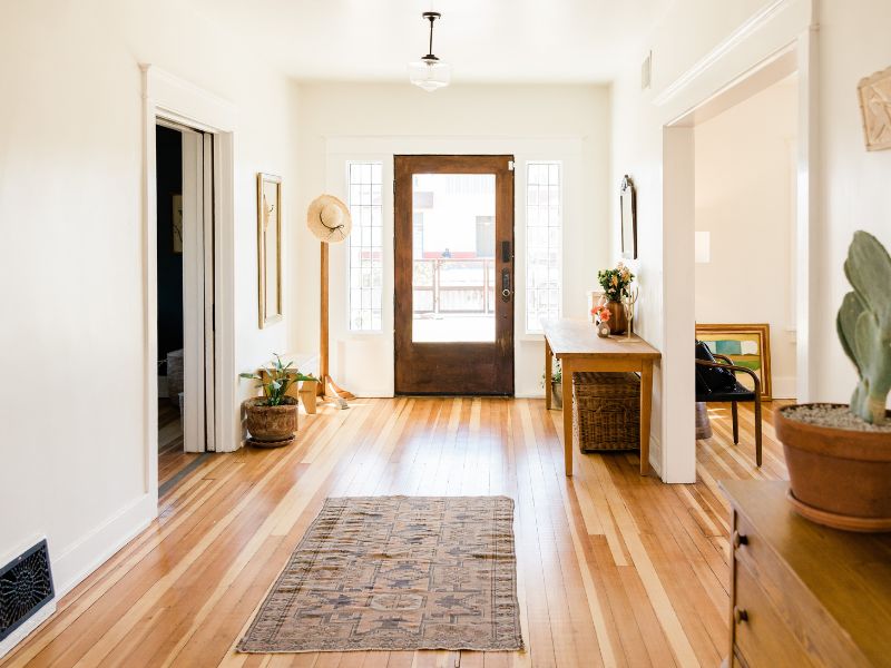 Bright entryway of a Texas Hill Country home with wood floors, natural light, and modern rustic decor. Bright entryway of a Texas Hill Country home with wood floors, natural light, and modern rustic decor.