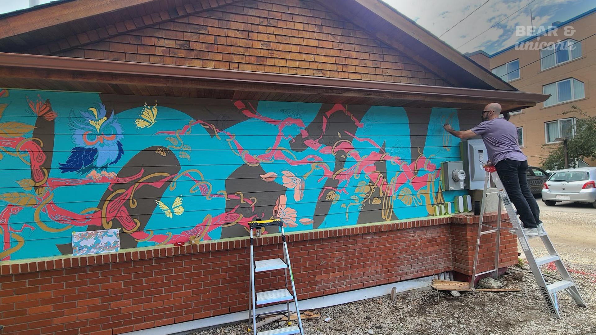Final Touch ups by Maya & David – "Mural artists Maya and David after attendees contributed to the interactive mural experience. Final Touch ups by Maya & David – "Mural artists Maya and David after attendees contributed to the interactive mural experience.