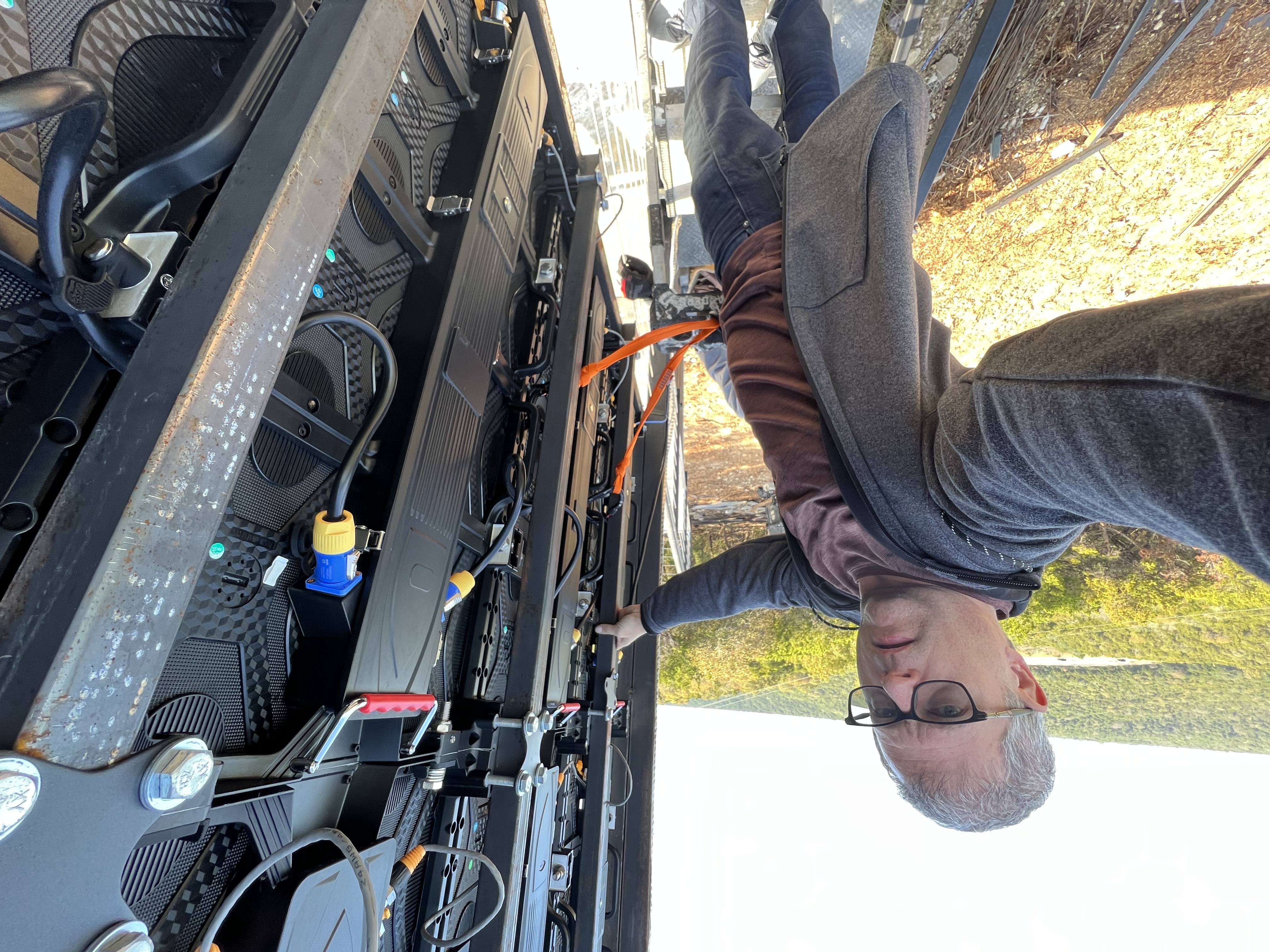 YOLO Technician hanging 20ft from the ground while installing YOLO Outdoor TV 158