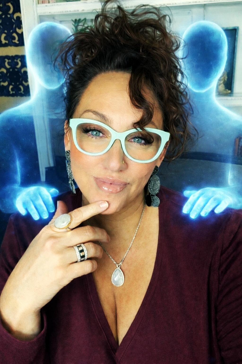 A person meditating with a glowing blue aura, blocking news and social media stress.