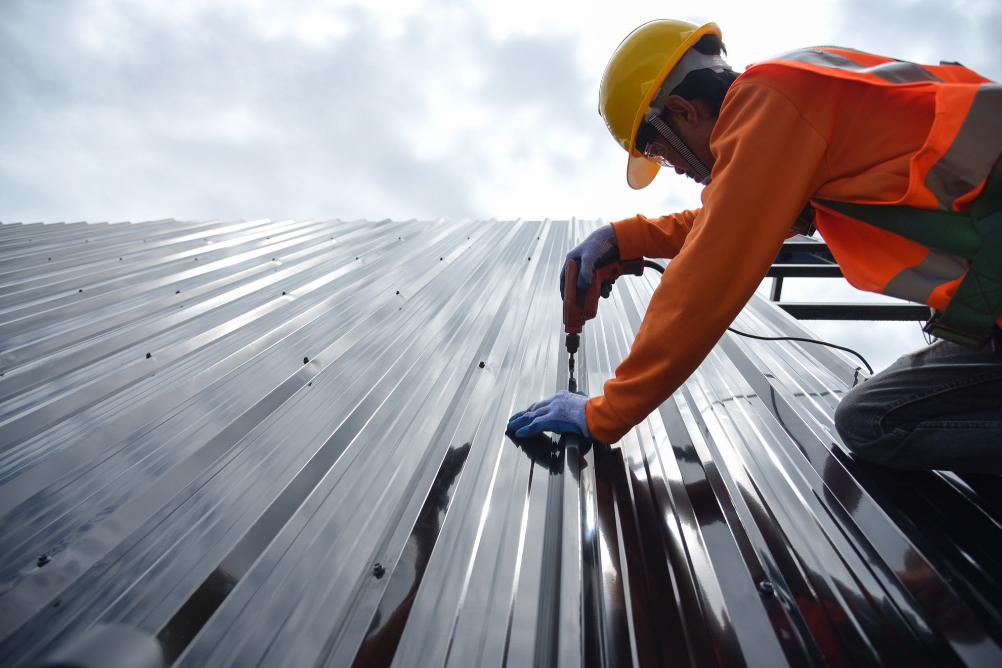 roofer installing metal roofing