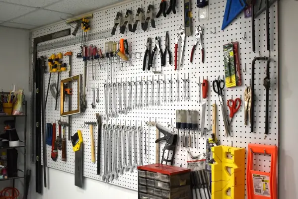 Wall-mounted shelves and hooks for garage organization