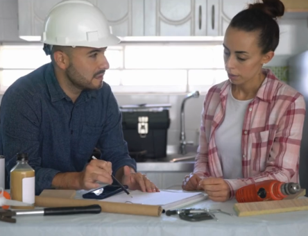 Contractor Reviewing Quote with Client Contractor Reviewing Quote with Client