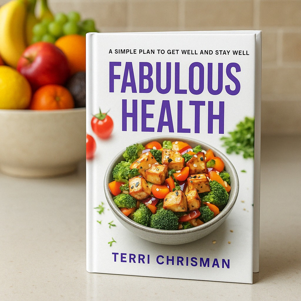 hard cover of Fabulous Health book on a table with a fruit bowl