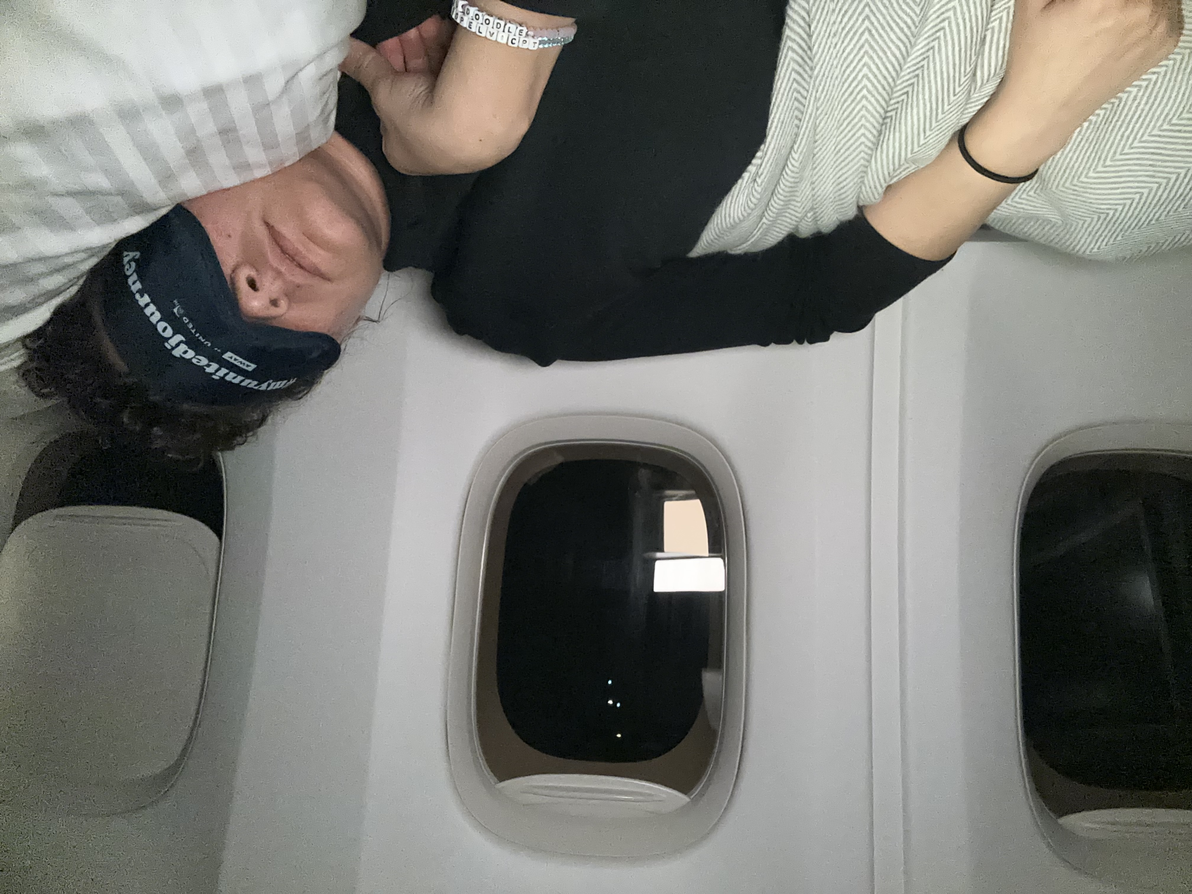 Kelly sleeps on the airplane.