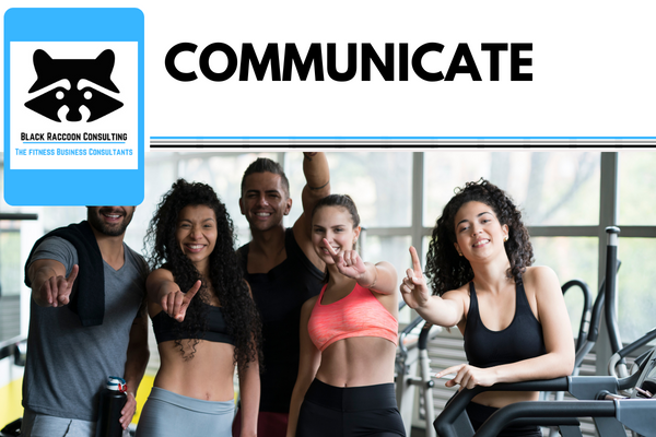  "Fitness business owners discussing communication strategies in a gym setting."