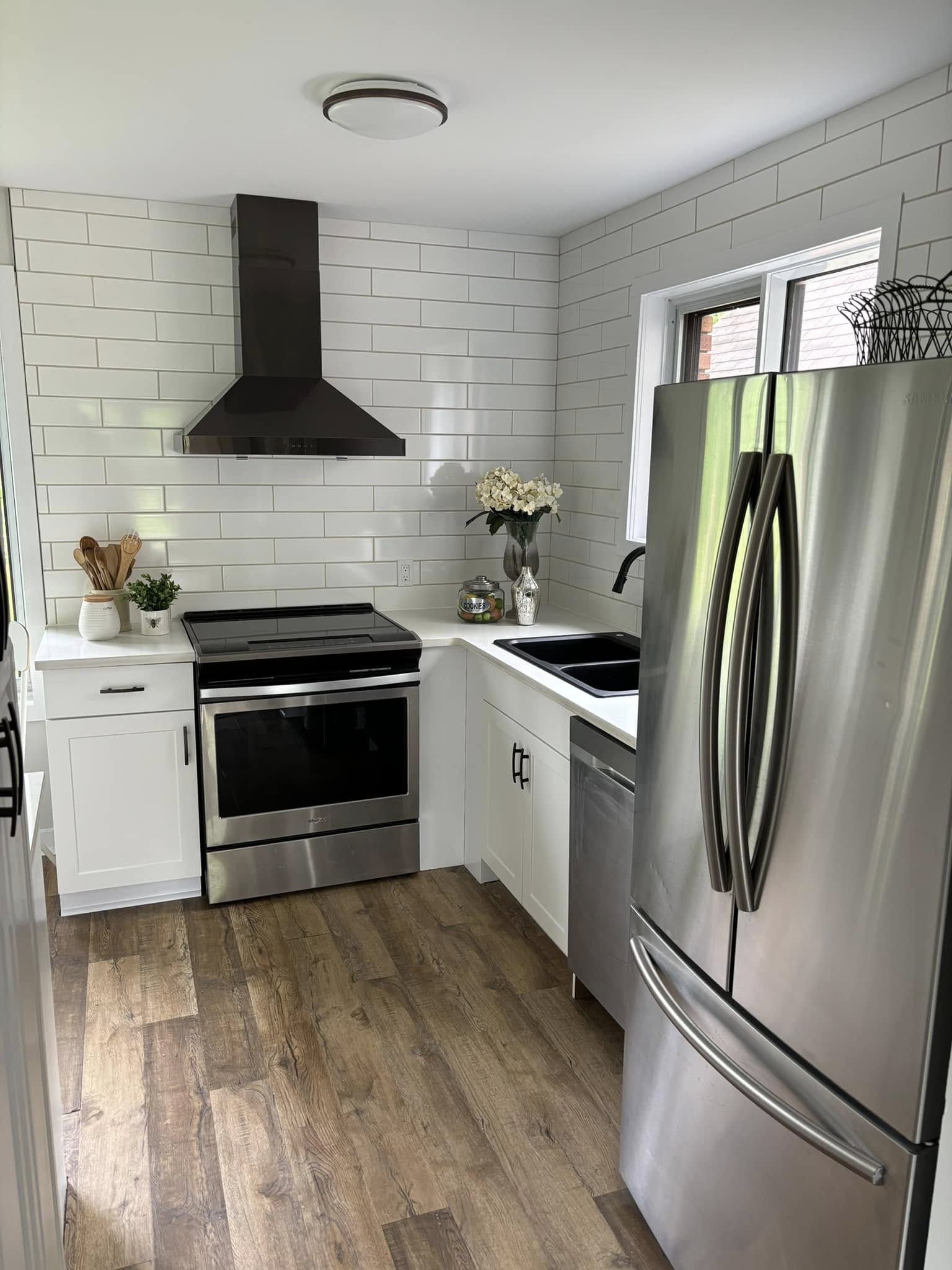 White kitchen renovation with stainless fridge