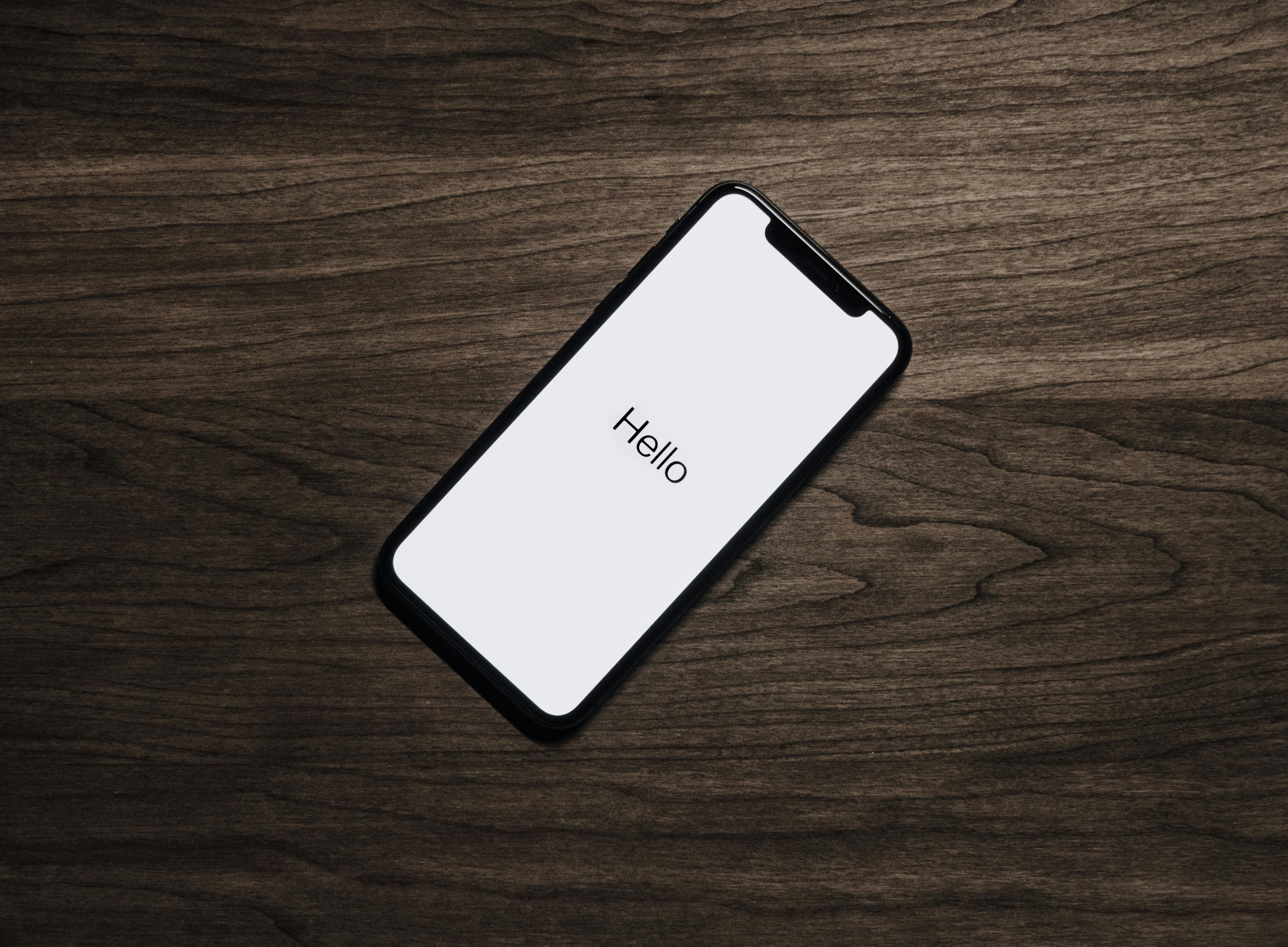 iPhone X mockup featuring a sleek design and a colorful home screen filled with app icons. iPhone X mockup featuring a sleek design and a colorful home screen filled with app icons.