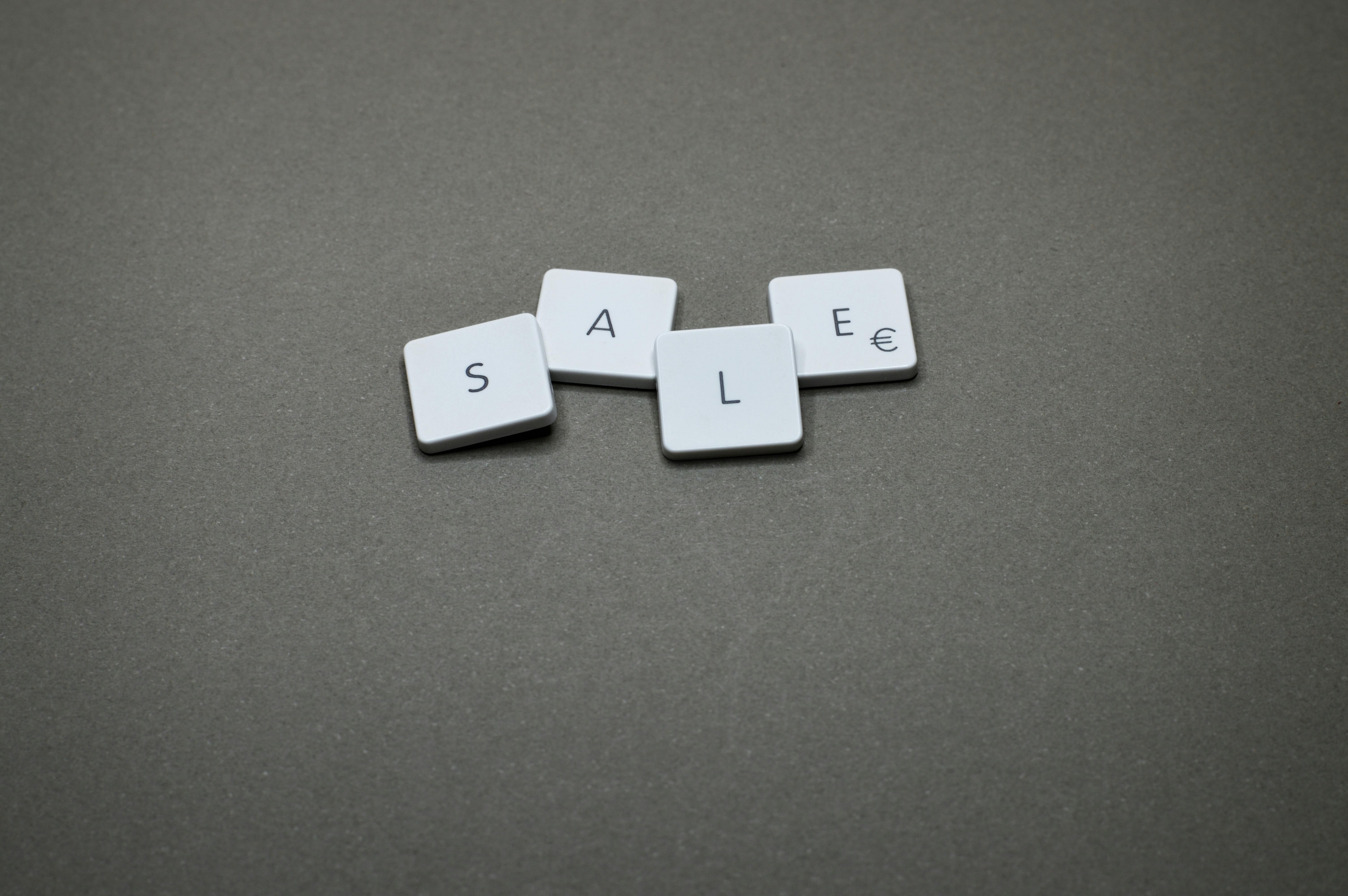 The word "sale" spelled out in white keys against a solid black background. The word "sale" spelled out in white keys against a solid black background.