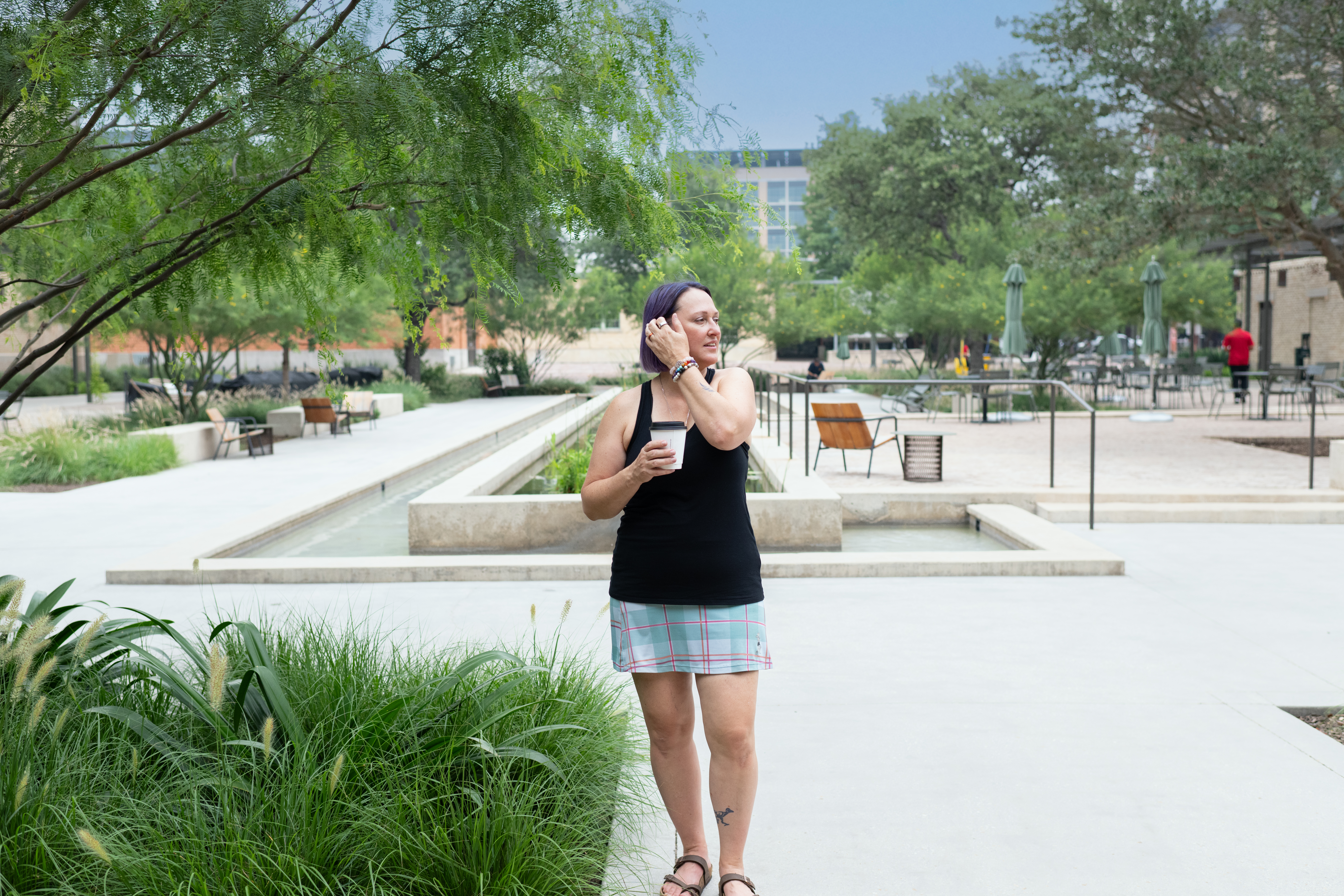 author outside holding coffee