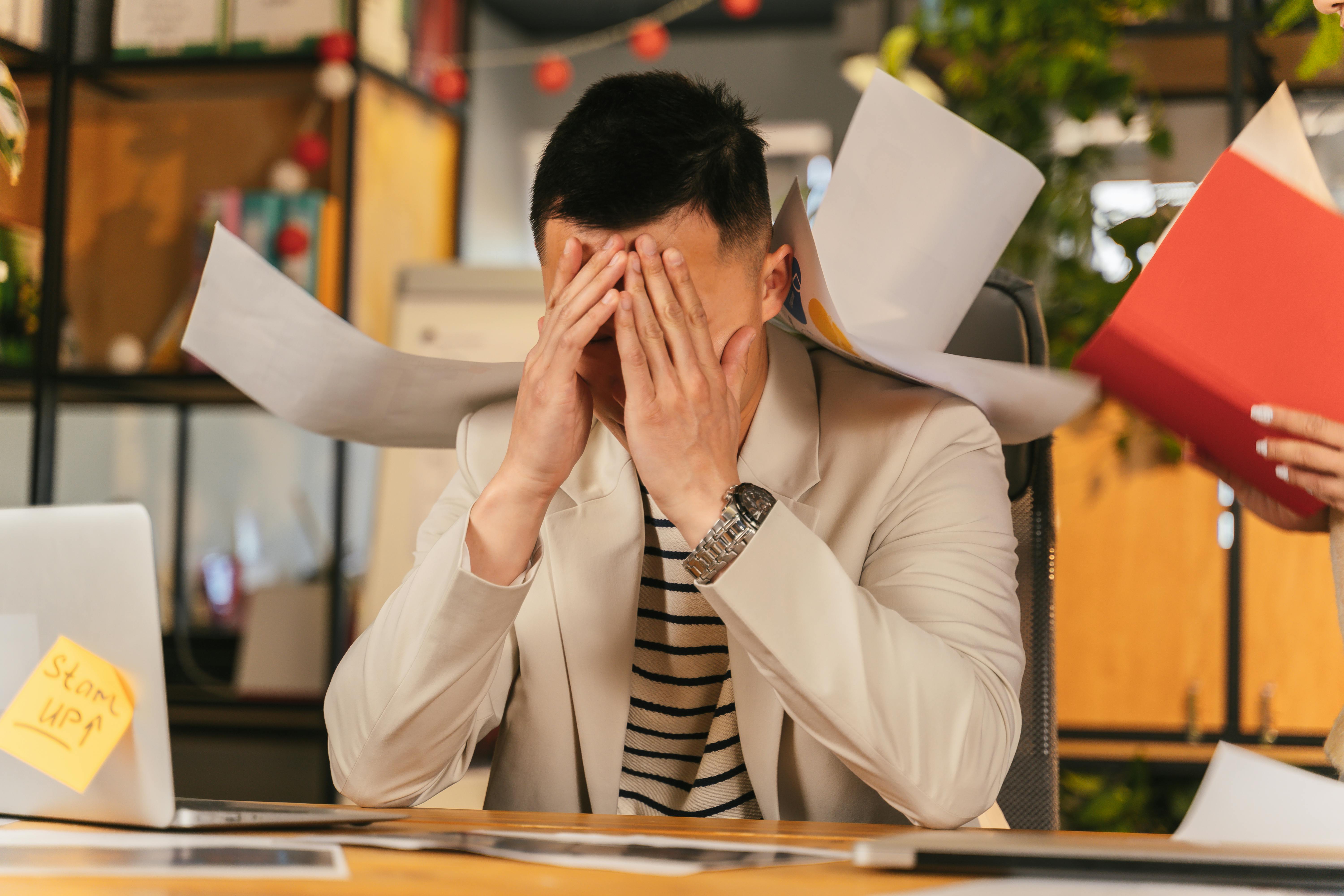 man stressed at work man stressed at work