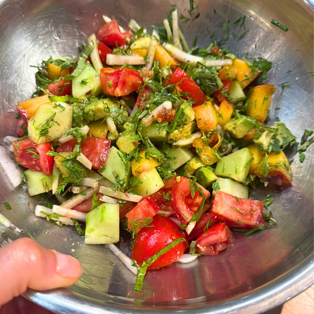 Fresh summer salad with peaches and tomatoes in a bowl Fresh summer salad with peaches and tomatoes in a bowl