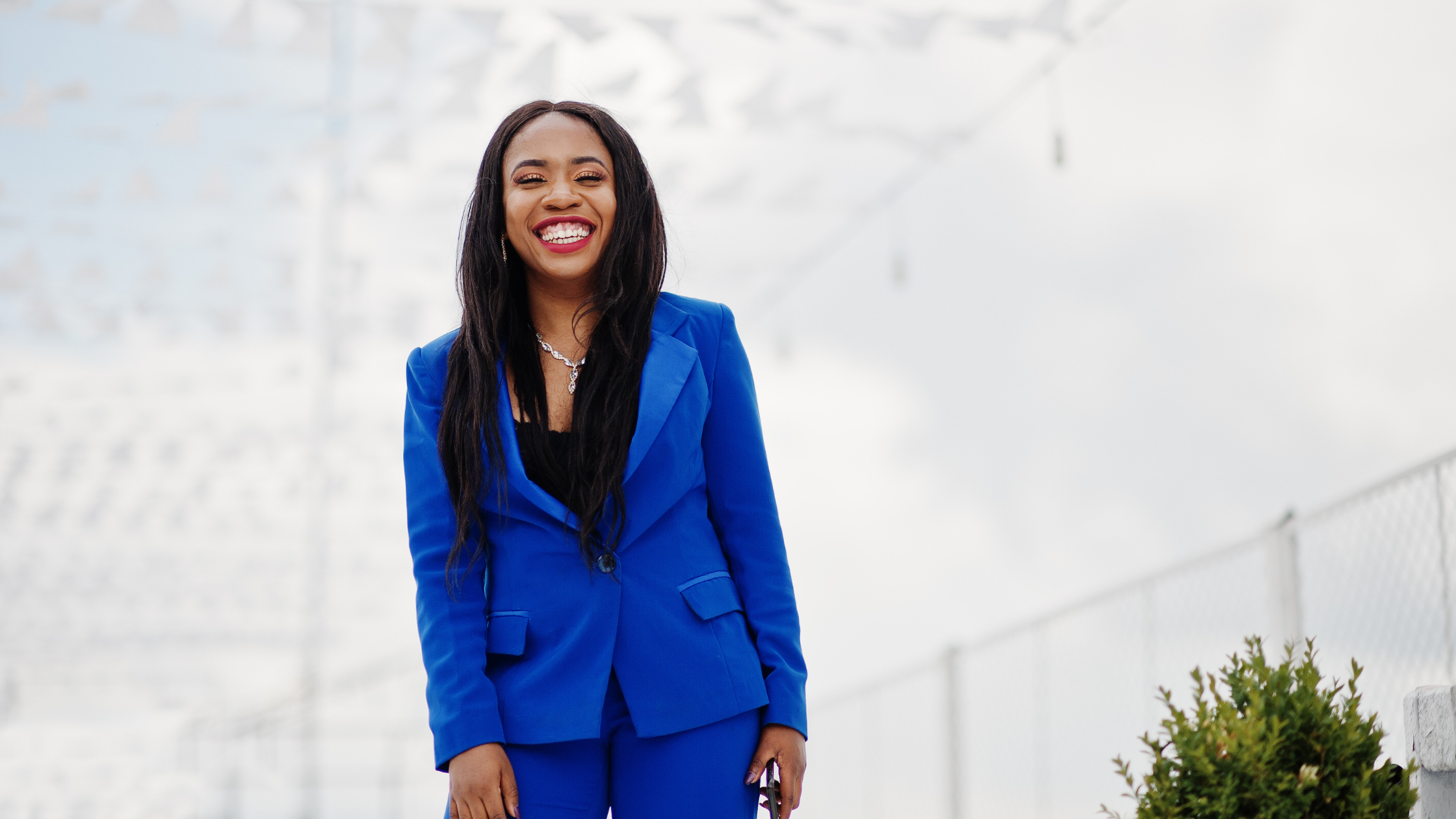 Successful Black woman in a blue suit smiling confidently, representing strength, resilience, and empowerment during divorce. Successful Black woman in a blue suit smiling confidently, representing strength, resilience, and empowerment during divorce.