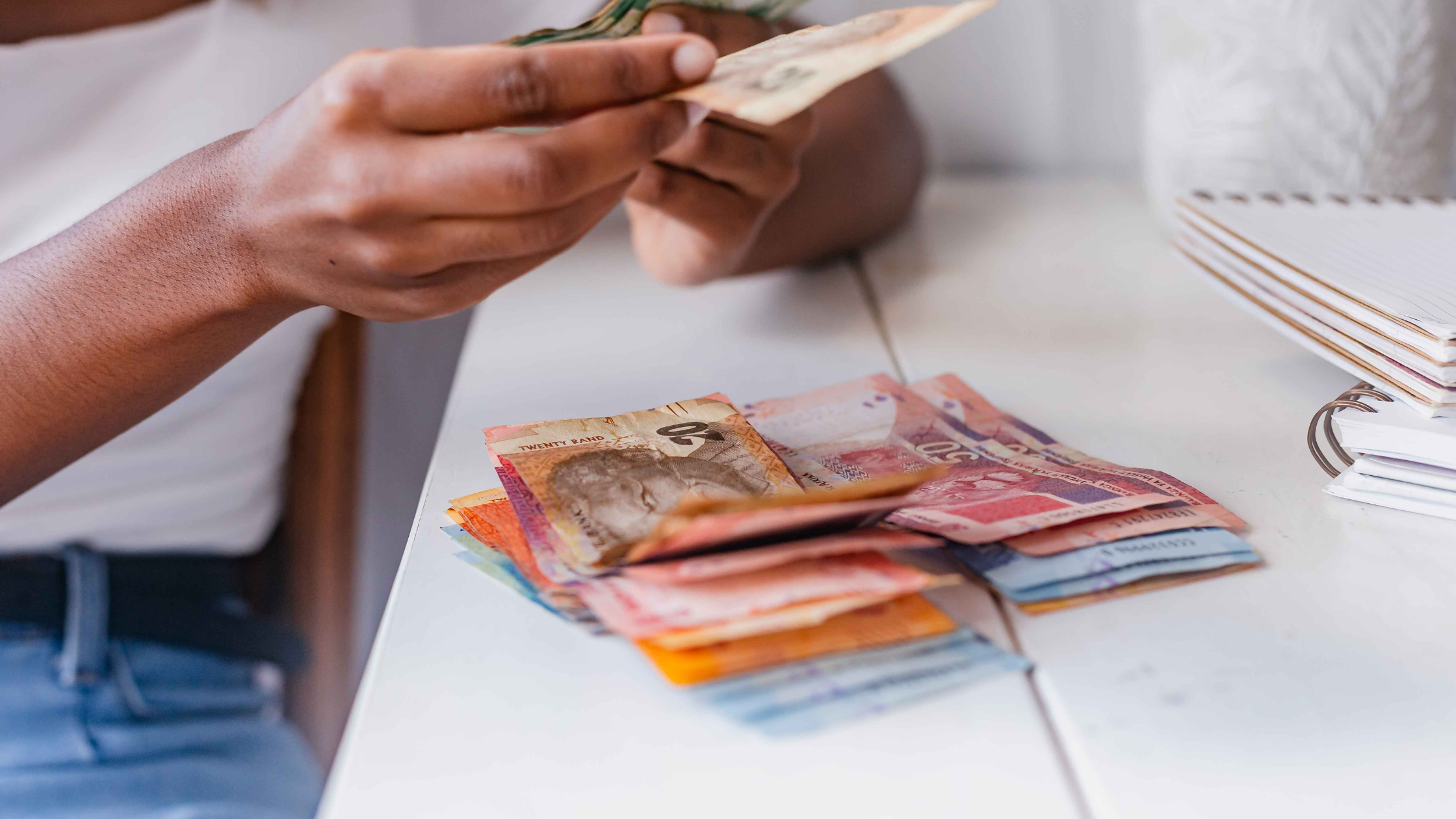 Black woman carefully counting money, managing finances and assets during divorce. Black woman carefully counting money, managing finances and assets during divorce.